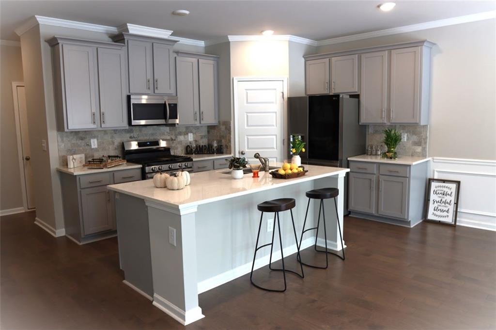 "Don't miss out!!!" Like-new 3 bed/2.5 bath townhouse is ready to move in. The open-concept first level a spacious bright kitchen with white cabinet, granite countertop, oversized island, and stainless-steel appliance. Upgraded all hardwood floors run throughout the main floor and stairs. Upstairs include a large master suite, two large secondary bedrooms with wooded views along with oversized laundry room. Courtesies are also included with a pool, clubhouse, and playground which is excellent for family enjoyment. All of this package with low HOA fees. Convenient location with easy access to Duluth, Norcross, and Downtown Atlanta.