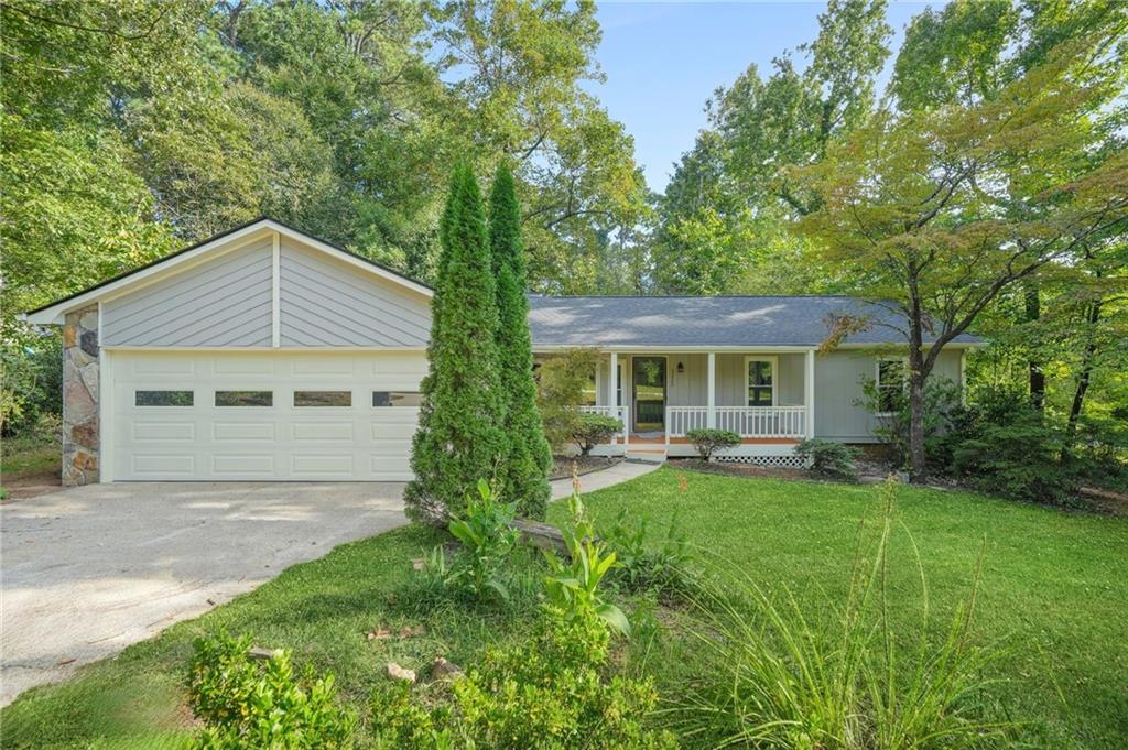 Better Than New, this beautiful one-level home sits on nearly half an acre in a peaceful cul-de-sac, offering the perfect blend of comfort, style, and convenience. From the moment you arrive, the freshly painted exterior and inviting curb appeal set the tone for what’s inside. Step through the door and feel the warmth of a freshly painted interior that gives every room a crisp, modern glow. The kitchen is the true centerpiece, showcasing gleaming quartz countertops, timeless finishes, beautiful upgraded lighting, and brand new tile that flows seamlessly into the breakfast area. Matching quartz in the bathrooms adds an extra touch of sophistication. Luxury vinyl plank flooring extends throughout the living spaces, while brand new carpet in the bedrooms creates a soft retreat at the end of the day. Gather with loved ones around the cozy fireplace in the family room, or step out to the private back deck, perfect for grilling, entertaining, or simply enjoying the serenity of your oversized lot. Every detail has been thoughtfully upgraded, including brand-new Low-E windows, a brand-new roof, and the peace of mind that comes with them. Just minutes from Stone Mountain Park, major highways, shopping, restaurants, schools, and more, this home combines a quiet setting with unbeatable convenience. Homes like this don’t last. Schedule your showing today and discover why this one truly feels better than new.