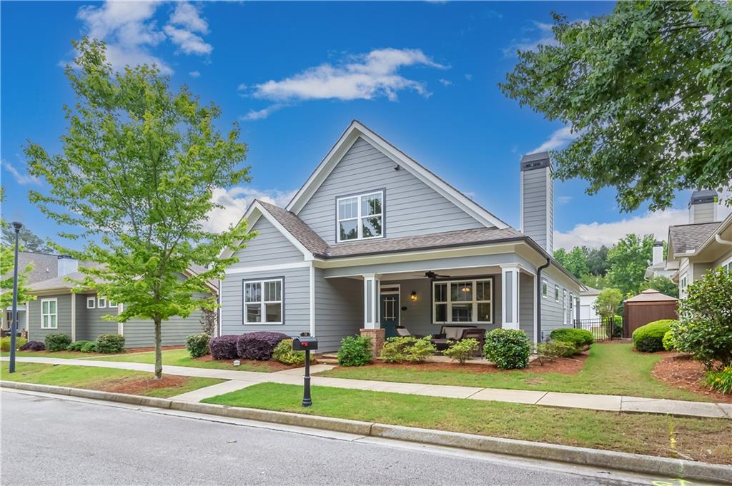 Welcome home to a truly captivating residence nestled in the heart of Grayson. This home effortlessly blends comfort, elegance, and functionality, promising an unrivaled living experience for its future homeowners. The spacious rocking chair front porch greets you as you step onto the gleaming hardwood floors that adorn the main level. The open floor plan allows for seamless transitions between spaces, encouraging a harmonious flow throughout the house. As you traverse the inviting layout, you'll be drawn into the large kitchen showcasing granite countertops, ample cabinet space, and stainless-steel appliances. An additional breakfast nook by the kitchen is perfect for those early morning coffee moments or casual weekday dinners. The laundry room has extra cabinet space as well as a beautiful barn door (Washer & Dryer Included). Comfort meets luxury in the master bedroom located conveniently on the main level. This serene retreat boasts ample space, a generous walk-in closet, and an en-suite bath that offers a garden tub and tiled shower with frameless shower door. Two additional spacious bedrooms and another full bath can be found upstairs. Step outside onto the covered patio to be greeted by a picture-perfect fenced yard. Whether you're hosting weekend barbecues or savoring quiet evenings, this outdoor haven offers the perfect setting. The HOA covers your lawn care so no need to worry about mowing! Located in a quiet and well-maintained neighborhood that’s close to everything Grayson has to offer, so don't miss the opportunity to make this beautiful property your new home.