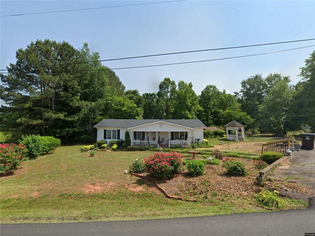 Great location with almost 2 acres. 3 bedroom 1 bath home with an additional home in the back of the property that is in need of repairs.