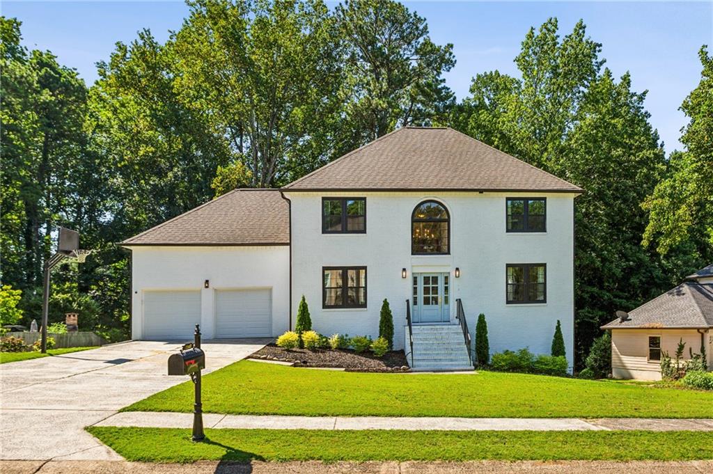 Welcome to this beautifully renovated two-story brick traditional, ideally located in the heart of Marietta and zoned for the highly sought-after Addison Elementary School. This open and airy home is move-in ready with gorgeous new hardwood floors, upgraded windows, and completely renovated kitchen and baths throughout. On the main level, the chef’s kitchen shines with quartz countertops, stainless steel appliances, gas range, oversized island with bar seating, and a cozy breakfast nook that leads to the back deck—ideal for grilling and dining al fresco. The inviting living room boasts a beautiful fireplace and a stunning wet bar complete with wine fridge and ice maker—perfect for hosting. Upstairs, the primary suite is a true retreat, showcasing tray ceilings and a spa-inspired bath complete with a soaking tub inside a glass-enclosed shower, dual vanities, abundant cabinetry, separate water closet, and two spacious closets. Three additional upstairs bedrooms share a large hall bath with double vanity, along with a generous laundry room. The terrace level offers incredible flexibility with a full in-law suite featuring a private entrance, spacious bedroom, large rec area, full bath, full kitchen, and secondary laundry hookups—perfect for guests, multi-generational living, or rental income. The recently regraded and landscaped backyard is ready for play and entertaining with fresh sod and dual-level deck access. Additional highlights include a two-car garage with ample storage, newly landscaped yard, and thoughtful finishes throughout. This is a rare opportunity to own a turn-key home with space, style, and function in an unbeatable East Cobb location.