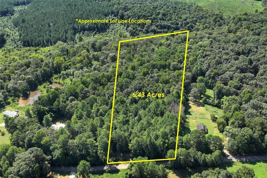 6.43 Acres - Prime Location Near I-85 & Banks Crossing Discover the perfect setting to build your dream home on this 6.43-acre property. Conveniently located just minutes from I-85 and Banks Crossing, you'll enjoy quick access to shopping, dining, and everyday conveniences while still having the privacy and space you desire. A peaceful creek runs through the property, adding natural beauty and a serene backdrop to your future home. With ample room for your custom home, outdoor living, or even a hobby farm, this property offers endless possibilities.