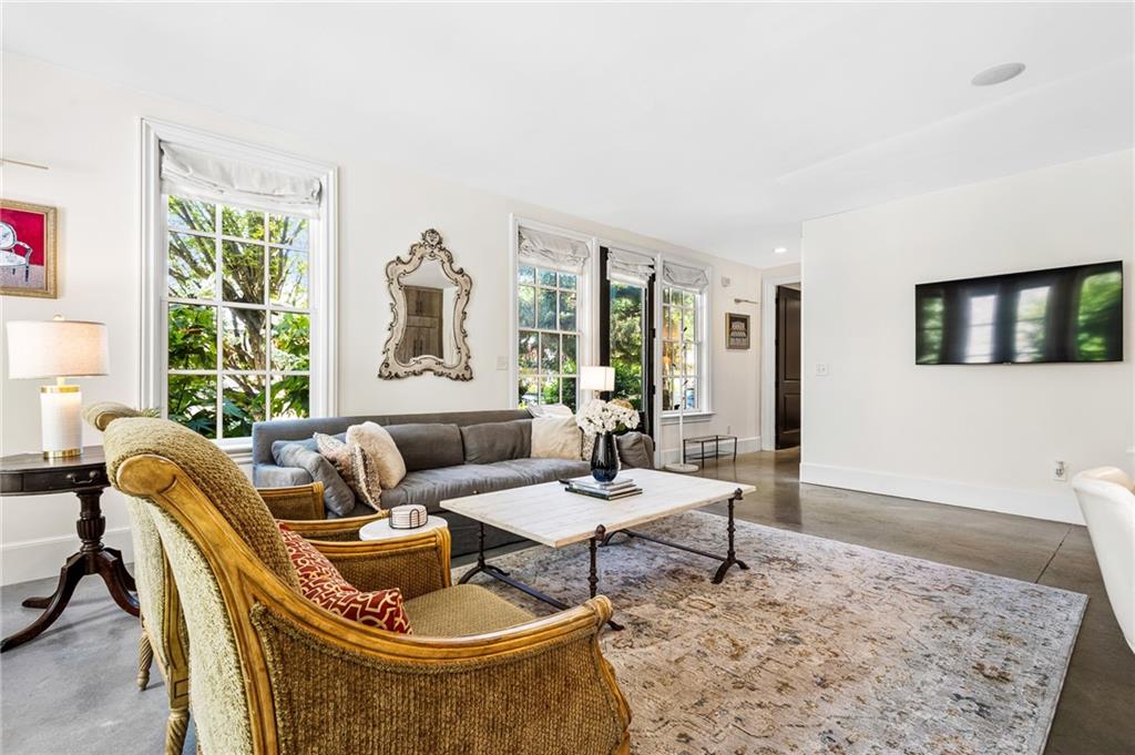 Living area with concrete floors and baseboards