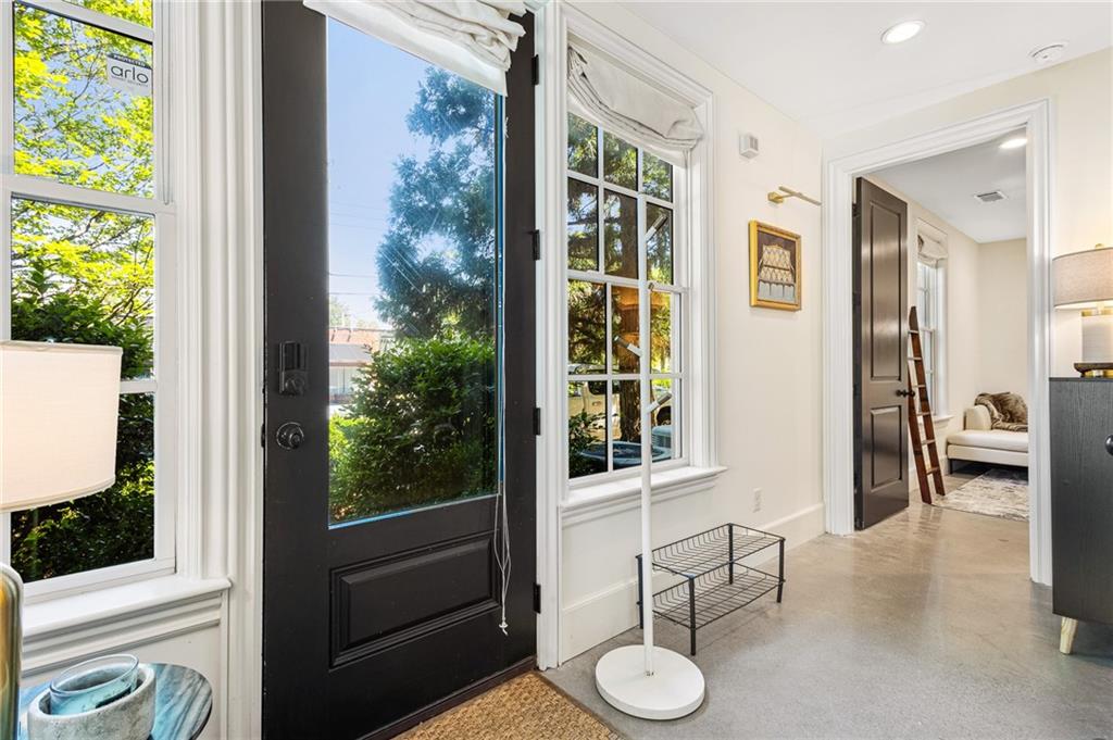 Doorway featuring plenty of natural light, recessed lighting, and concrete flooring