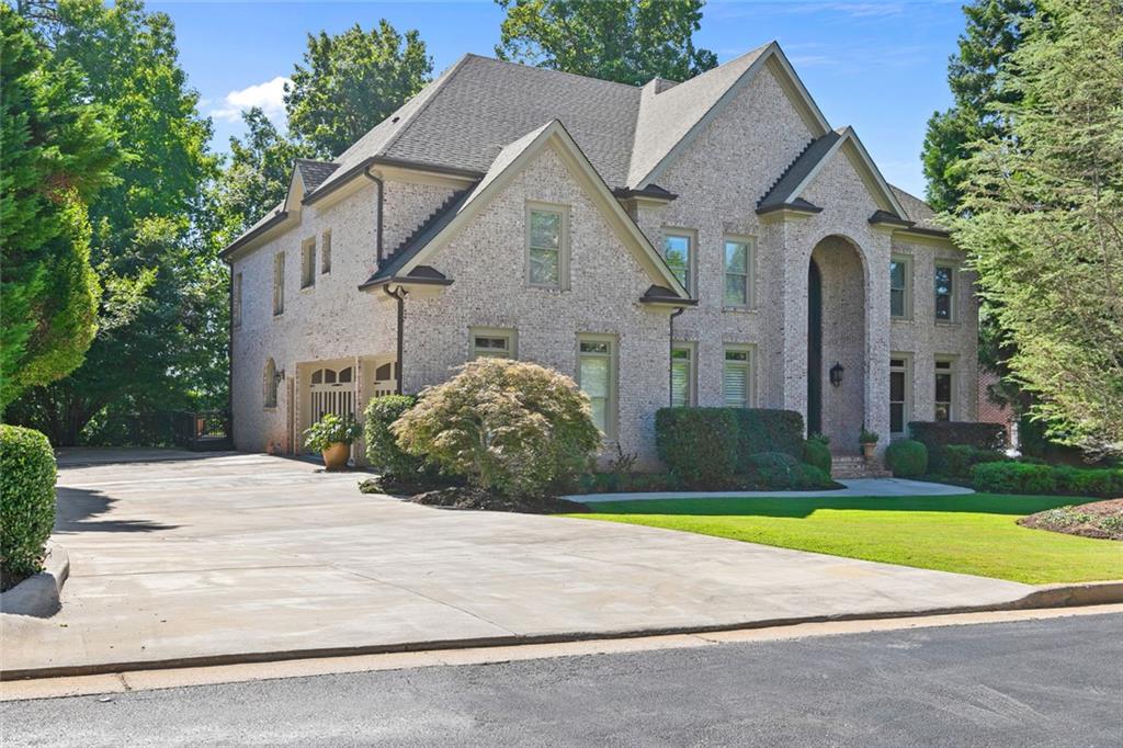 EXQUISITE LUXURY LIVING IN ST MARLO COUNTRY CLUB! This all-brick executive residence sits on a beautifully landscaped flat lot with a fully fenced private backyard oasis—perfect for future pool installation and outdoor entertaining. The home boasts a new roof, gutters, exterior and interior paint (2025), three new HVAC units (2024), new hot water heaters (2025), refinished wood flooring (2025), and a resurfaced 900 sq ft TREX deck that spans the rear of the home, offering ample space for a future covered outdoor living area. The expansive 2,625 sq ft flat driveway provides generous parking for family events and guest gatherings. Step through the custom 8-foot double iron decorative doors into a grand two-story foyer with soaring 20-foot ceilings and elegant millwork. The entry opens to a richly appointed custom-paneled home office, banquet-sized dining room, and a grand fireside living room with coffered ceilings. The flowing open layout continues into the gourmet kitchen, which features custom-designed cabinetry, premium-grade natural stone countertops, a large center island, stainless steel appliances, a five-burner cooktop, commercial-grade vent hood, and a bright breakfast area with a second fireplace—an ideal setup for entertaining friends and family.
The main-level guest suite offers privacy and comfort, complete with a full bath featuring a walk-in natural stone shower. Upstairs, the home features four oversized en suite bedrooms, each with its own private bath and walk-in natural stone shower. The vaulted owner’s suite is a luxurious retreat with a fireplace, huge jacuzzi tub, custom cabinetry, Grade A natural stone countertops, dual vanities, and an expansive walk-in closet.
The finished terrace level is designed for elevated entertaining and relaxation. It features a spa-style bath with a custom walnut vanity, huge walk-in natural stone steam shower, four-person jacuzzi, and large sauna. Additional spaces include a fireside family room, a theater room, a billiards area, and a custom walnut bar with tumbled marble countertops. The full kitchenette includes a wine cooler, ice maker, refrigerator, and dishwasher—ideal for hosting. A bonus room can easily be converted into a cigar lounge or wine room, and an under-stair closet is perfect for a wine rack installation.
Additional upgrades include strategically placed built-in speakers throughout the interior and exterior, prewiring for security cameras, audiovisual, and high-speed internet, and professionally designed landscape lighting in both the front and rear yards. Multiple fireplaces and custom finishes enhance the elegance and comfort of this spectacular home.
Located in the prestigious, gated St Marlo Country Club, this home offers access to resort-style amenities, low Forsyth County taxes, and top-rated schools. Experience unmatched quality and comfort in one of Georgia's most exclusive golf communities.
Shown by appointment only—don’t miss this entertainer’s dream home!