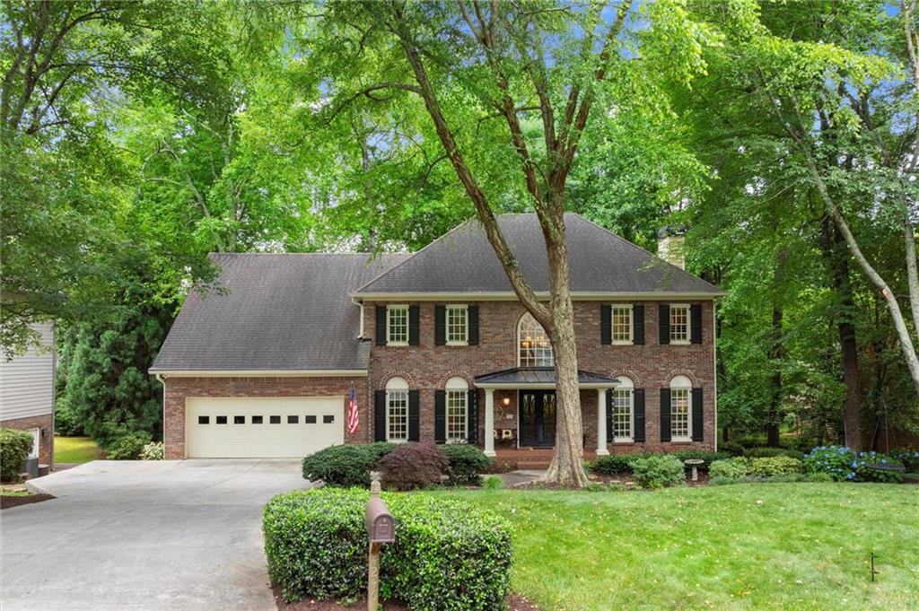 Welcome to your dream home in one of the most sought-after swim and tennis neighborhoods in East Cobb. Nestled on a flat, centrally located lot near the amenities, this beautifully updated home offers and inviting flow blended with timeless charm. You’ll first notice the lush front yard with park-like landscaping, durable Hardiplank siding, and a classic brick-front exterior that adds timeless curb appeal. Enter through the custom steel double doors into the two-story foyer, where gleaming hardwood floors and abundant natural light create a warm and inviting atmosphere. The main staircase has been painted and upgraded with a custom runner, and nearly every switch and receptacle in the home has been updated for a fresh, cohesive look. Gather in the eat-in kitchen featuring stainless appliances, including a brand-new Bosch dishwasher, new KitchenAid gas cooktop, KitchenAid convection oven/microwave combo, and a separate pantry. Cozy up and enjoy your favorite beverage fireside in the family by the painted brick fireplace surround with built-ins for extra storage. Enjoy quality time year-round on the serene screened-in porch overlooking the spacious backyard filled with abundant wildlife. Unwind with loved ones in this space perfect for meals, conversation, and soaking in the tranquil, wooded backdrop. Enjoy quality time year-round on the serene screened-in porch overlooking the
backyard filled with abundant wildlife, a favorite spot for meals, conversation, and soaking in the tranquil, wooded backdrop with loved ones. Just outside, the new Trex deck is ideal for grilling and entertaining, and the fenced-in backyard with playset provides ample room for fun. The laundry room on the main includes custom cabinetry for added storage and functionality. Retreat upstairs to the spacious primary suite featuring a trey ceiling and walk-in closet. Indulge in the completely updated en-suite bathroom, complete with a double granite vanity, updated lighting and fixtures, tile floors, a separate tub, and a tiled walk-in shower with built-in shelving. New high-end carpet and premium padding have been added throughout the upstairs. The remaining bedrooms are generously sized, each with ceiling fans and shared access to another fully renovated bathroom featuring modern tile, a double granite vanity, updated mirrors, and fixtures. The powder room was also updated with a new vanity, lights, paint, flooring, and wainscoting. Both levels of the home benefit from high-efficiency Carrier HEPA/UV HVAC systems with internet-enabled thermostats, zoned for optimal comfort on the main and terrace levels. Downstairs, the finished terrace level is the ultimate hangout spot, perfect for watching the big game or hosting casual gatherings. With fresh paint throughout select rooms,
ample storage, and a MyQ smart garage opener, this level ensures convenience and space for all your needs. The garage features custom
storage solutions, an oversized layout for a small third vehicle or workspace, and a handy storage closet in the back. The location is unbeatable, just a
short stroll to the lake, scenic walking trails, and neighborhood amenities including a pool, tennis courts, playground, and clubhouse. Set in one of
East Cobb’s most sought-after communities, you’ll enjoy vibrant year-round events, top-rated schools, and a prime location close to everything you need. Don’t miss your chance to call this dream home yours.