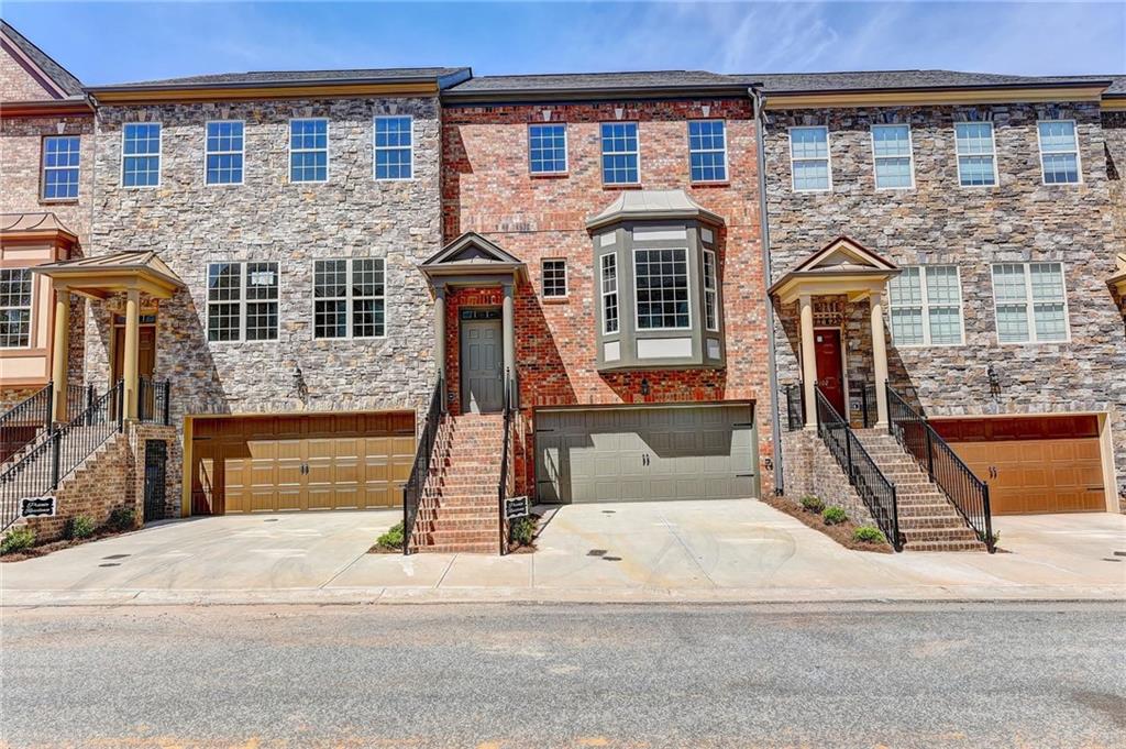 Freshly painted. Pristine condition. Vacant. Pool view unit. Gated townhome community with easy access to I-75 and I-285,shopping and The Battery Atlanta. Open-concept main level is perfect for entertaining. The spacious,eat-in kitchen features a large top island, granite countertops, and a tile backsplash. Finished basement with a full bath could be used as a fourth bedroom,office,or family room.