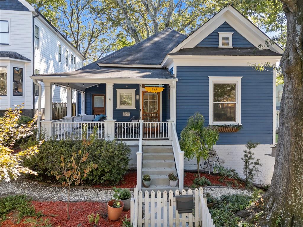 Step inside 245 Georgia Ave SE and prepare to fall for a house with serious main-character energy. This 1905 Grant Park beauty mixes vintage charm with modern cool — think tall ceilings, gleaming hardwoods, and two fireplaces that are just begging for vinyl records and craft cocktails. The wraparound porch is pure Southern magic — morning coffee, evening wine, or lazy Sunday hangs with your people (and your pup). Inside, the kitchen is equal parts style and substance, with granite counters, stainless appliances, a custom walk in pantry and the perfect vibe for everything from homemade pasta nights to DoorDash deliveries. Two spacious bedrooms and two full baths including a true primary suite, make this the ideal city retreat — cozy, low-maintenance, and full of character. Custom folding glass doors extend your entertaining space to the private deck and fenced yard - your own pocket of serenity, complete with off-street parking and EV charger. Just steps from Grant Park’s trails, indie coffee shops, and all the buzzy spots in Summerhill like Little Tart, Big Softie and Halfway Crooks, that make Atlanta fun, this place hits the sweet spot between old-school soul and modern city life. 245 Georgia Ave isn’t just a home — it’s your next cool chapter waiting to be written.
