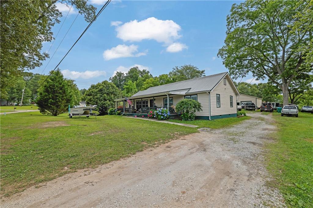 Discover this lovingly maintained 1952 gem on over 2 private acres. Features 4 bedrooms & 2 beautifully appointed custom bathrooms. Enjoy peace of mind with a durable metal roof and the ease of brand-new appliances. Detached 2-car garage & sprawling lot complete this picture-perfect ranch home.