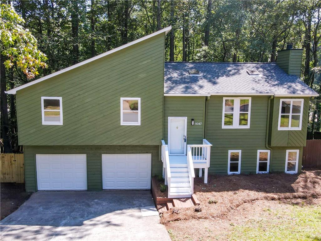 Nestled in a serene wooded lot, this meticulously renovated home offers a harmonious blend of modern amenities and natural beauty. From the roof to the HVAC system, every detail has been thoughtfully updated to provide a comfortable and stylish living experience. Key Features include Smart Lighting: Enjoy the convenience of smart light fixtures in the hall way, allowing you to set the perfect ambiance with ease. The kitchen boasts white cabinetry complemented by sleek quartz countertops, offering both beauty and functionality. Brand new stainless steel appliances complete this chef's dream space. Luxurious Bathroom: Relax in the modern bathtub, designed for ultimate comfort and style. Master Suite Retreat: The master bedroom features private balcony access, perfect for enjoying a fall morning coffee while overlooking the picturesque wooded lot. Spacious Living Areas: Thoughtfully updated LVP flooring flows seamlessly throughout the the house, while plush carpeting in the bedrooms adds warmth and coziness. Finished Basement: The expansive finished basement offers versatile living space. Storage room behind the garage gives the homeowner a place to organize their belongings. Adding a bathroom would make it an ideal suite for a loved one or guests. Outdoor Oasis: Step outside to a cabin-like porch accessible from two rooms, offering a peaceful retreat. The natural cedar-colored deck and stairs provide access to the private wooded backyard, perfect for barbecues and outdoor gatherings. Two Car Garage: Ample space for vehicles and storage needs. Updated Systems: The home features a new water heater and an upgraded HVAC system, enhancing energy efficiency and comfort. This home is a rare find, combining modern upgrades with the tranquility of nature. Whether you're entertaining guests or enjoying a quiet evening, this property offers the perfect setting. Don't miss the opportunity to make this beautifully renovated house your new home.