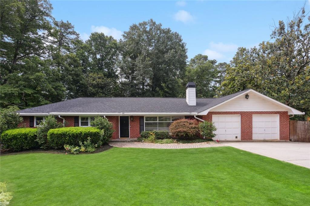 Beautifully updated and meticulously maintained all brick ranch in the heart of Smyrna. Nestled on half an acre, this home offers 4 bedrooms and 3 full baths across a spacious layout with tons of charm throughout! Updated kitchen with tile backsplash, recessed lighting, a breakfast bar, a newer refrigerator, and newer appliances including a new dishwasher and microwave. Impressive owner’s suite features a private deck overlooking a gorgeous, landscaped backyard. Generous master bath with double vanity, jetted tub, separate water closet, frameless shower and built in walk in closet. Hardwood floors and fresh interior paint throughout the main level. Just off the kitchen, the cozy family room flows seamlessly to a screened-in porch and extended deck—perfect for entertaining or relaxing outdoors! Step outside to your fenced-in backyard retreat featuring a koi ponds, fire pit, patio and storage shed. Kids and kids-at-heart will love the zip line, rope swing, teeter totter, balance beam, trampoline, and climbing dome. Additional updates include a 3-year-old roof, newer water heater, and newer driveway. Full daylight basement features guest/in-law suite, full bathroom and recreational space. Enjoy unbeatable convenience with quick access to The Battery Atlanta, Truist Park, Smyrna Market Village, Vinings Jubilee, the Silver Comet Trail, and more. This home truly offers the perfect blend of modern comfort, classic charm, and proximity to dining, shopping, I-285/I-75 and entertainment!