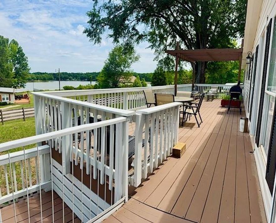 Welcome to peace and serenity with stunning views of Skyland Lake! This beautifully updated 3-bedroom, 2-bath modular home offers modern style, comfort, and an unbeatable location. Step into an open floor plan with cathedral ceilings, abundant natural light. The fully remodeled kitchen is a standout, featuring sleek white cabinetry with under-cabinet lighting, granite countertops, a spacious granite island, and a large pantry—perfect for cooking, entertaining, and everyday convenience. The bathrooms have been tastefully updated with modern tile shower and tub surrounds, offering a clean, luxurious feel. The primary suite includes a walk-in closet and private bath, creating a relaxing retreat. Enjoy peace of mind with a new roof and many recent upgrades already completed. Not in a park—you OWN the land! And even better—this property is not located in a flood plain. The level lot makes yard maintenance easy and offers plenty of space for kids, pets, gardening, or outdoor entertaining. Best of all, you're just steps from beautiful Skyland Lake, where you can relax, take in the view, or launch your kayak for a peaceful paddle. Additional highlights include: Spacious walk-in closets / Public sewer—no septic system /Gorgeous Lake views from your front yard /Quiet, scenic neighborhood / Great for full-time living or weekend getaways Don’t miss this opportunity to own a stylish, low-maintenance home with access to nature and lakefront enjoyment—without the worry of flood insurance.