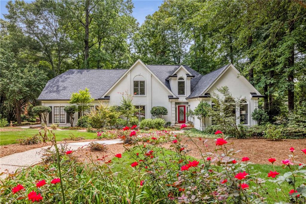 Welcome to this beautifully renovated one-owner home in the heart of Alpharetta! Ideally located just minutes from Wills Park, Avalon, and vibrant downtown Alpharetta, this move-in ready gem offers modern updates, a private backyard oasis with a POOL, and access to top-rated schools. Step inside to discover all-new flooring, including durable luxury vinyl plank on the main level, tiled baths, and plush carpet upstairs, plus fresh interior and exterior paint, and updated light and plumbing fixtures. The renovated kitchen features refreshed cabinetry with soft-close doors and drawers, a PANTRY, new stainless steel GE appliance package, and an open view to the spacious great room with a fireplace. The oversized primary suite is on the main level and features a custom walk-in closet, and a spa-like bath with separate vanities, a soaking tub, and frameless glass shower. A finished basement provides direct access to the pool deck and is perfect for entertaining, with a bar, resurfaced pool table, bedroom and full bath, ideal for guests or a private retreat. Outdoors, enjoy your newly updated deck, professionally landscaped grounds, a gazebo, and a private in-ground pool with a striking new liner and Trex decking - the perfect setting for summer relaxation and gatherings. Additional highlights include a NEW ROOF, newer HVAC systems (2023 & 2025), new electrical panel, and a universal Tesla EV charger in the 3-car garage. Don't miss this opportunity to own a thoughtfully upgraded home in one of Alpharetta's most sought-after areas!