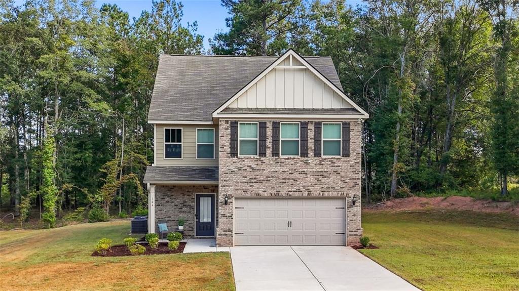 Search no more! Looking for more space, privacy, and value than the average new construction? This move in ready 5-bedroom, 3-bath home located in the highly sought-after Ola High School cluster offers just that! Built in 2022 and set on a level 0.87 acre lot with wooded privacy, this brick front property offers a rare opportunity to enjoy newer construction at a price below the current new builds in the community.
This freshly painted home boasts a smart, open-concept layout ideal for both everyday living and entertaining. High ceilings on the main floor enhance the spacious feel, while the living and dining combo centers around a modern fireplace and flows seamlessly into the island kitchen. Here, you’ll find stainless steel appliances, a walk-in pantry, and plenty of space for cooking, gathering, and hosting. Natural light pours into every corner, creating a warm and welcoming atmosphere throughout. The main level includes a private bedroom and full bath, perfect for guests or multi-generational living, as well as convenient access to the two-car garage and a long driveway that adds additional parking capacity.
Upstairs, vaulted ceilings elevate all four bedrooms. The oversized owner’s suite will be your ultimate place of retreat and relaxation with features such a large walk-in closet, linen closet, double vanity, and separate soaking tub and shower. Space for everyone in the family is never a question with three additional bedrooms offering generous layouts and ample closet space. The well-appointed split full bath offers flexibility, storage and comfort for everyone. The ample upstairs laundry room keeps everyday routines efficient and easy.
Outdoor living is just as comfortable, with a covered front porch perfect for relaxing and a rear patio overlooking the wooded portion of the lot that adds both privacy and peaceful views. The home is wired as a smart home and located in a serene HOA community where common area maintenance is included.
If you're looking for more space, more privacy, and more value than the average new build, this one checks all the boxes. Schedule your showing today and experience the difference for yourself.