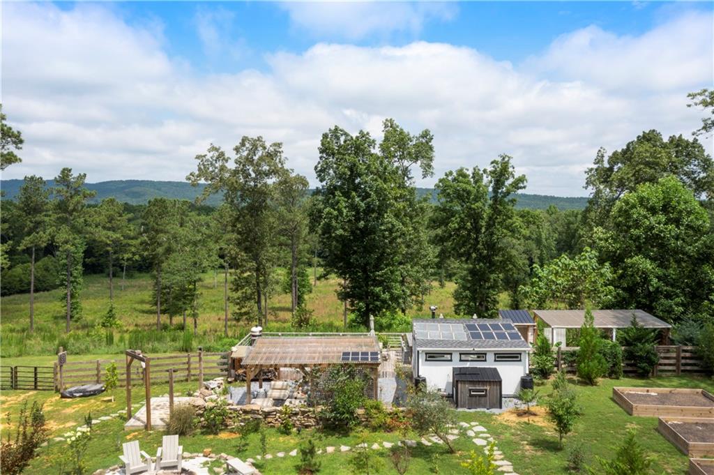 Ready to live off the land and embrace a lifestyle of freedom, nature, and sustainability? Don’t miss this rare opportunity to own a fully equipped 17.26-acre homesteading paradise—perfect for farmers, preppers, hunters, and outdoor enthusiasts alike. Whether you're looking to build, retreat, or reconnect, this property is move-in ready and waiting for your vision.
Discover this exceptional 17.26-acre property, offering a unique blend of outdoor living and rustic luxury. This amazing property has it all; rolling topography with cleared highpoints and low lying fields, thickly wooded treelines and fenced-in pastures, a plethora of orchard fruit trees and over 700' of Heath Creek flowing through it.
Essential utilities including permitted power at the street, fresh water via rainwater collection systems, and onsite WIFI are available.
Upon entering the semi-private gated entrance you'll drive alongside a large 2 acre pasture with robust 4-rail livestock fencing. Open another private gate and you'll enter the property at its highpoint where you will appreciate spectacular views.
This property is an outdoor enthusiast's dream, featuring a chef's outdoor kitchen equipped with a 6-burner grill, two warming drawers, a prep sink, a refrigerator, and a wine cooler/beer fridge. Relax by the large rock inground fire pit with a 30-foot gravel and accent rock surround, perfect for large gatherings. A custom, hand-laid outdoor stone wall and fireplace enclose a private covered area with fans and a solar-powered movie projector and screen.
Additional outdoor amenities include a Gozney wood-burning pizza oven, multiple rainwater collection containers, outdoor dart and knife throwing boards, and a huge covered gazebo. The property boasts multiple garden beds, berry bushes, and fruit trees, including muscadine, blackberry, blueberry, raspberry, plum, peach, apple, fig, cherry, pear, and persimmon.
For accommodations, an efficiency suite provides a cozy living space with a king-size bed, kitchenette (sink, microwave, toaster oven, two small refrigerators), and an office area. The space is heated by a cast-iron wood-burning stove and cooled by a portable AC unit, powered by solar panels and multiple power banks. Sliding glass doors offer stunning views of wooded fields and mountain sunsets.
Storage is ample with three 10X20 storage containers with covered work/storage space, a 200 sq ft. storage building permitted for electric hook-up, and another 200 sq. Ft. storage building with double barn doors, lofts, and wood floors. Pet amenities include three vented dog houses, one with solar access nearby.
Other unique features include a deer/game dressing area with a winch and pulley system, propane insta-hot water for outdoor showers, an outdoor potty with a view, and multiple deer stands. There are several ideal building sites available for future expansion.
Located just 4 miles from Rocky Mountain Recreation Area Campground and Beach on Antioch and Heath Lakes which combine for a total of 559 acres and are commonly known as Trophy Lake for its impressive fish population. 8.5 miles from Richard B. Russell Regional Airport. And 12 miles from Berry College.
Schedule your private tour today and experience firsthand what it means to live intentionally, independently, and in harmony with nature. Properties like this don’t come around often—claim your slice of self-sufficient heaven before it’s gone!