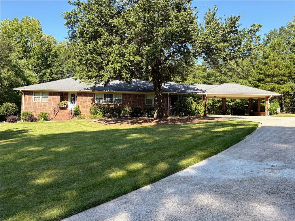 Welcome Home to this Immaculately maintained 4 Sided Brick rambling Ranch style home in the Heart of Douglasville. This classic home offers spacious living on a one+ acre lot. A Formal Foyer sets the tone leading to the Living and Dining Rooms, A Modern Chef's Kitchen and Family Room which overlooks the backyard. Enjoy outdoor living from the front of the home while sitting inside the cozy screened porch OR from the backyard from the deck OR poolside. The private pool awaits with generous decking for sunning and entertaining. Don't miss the additional building in the backyard. Perfect for Man Cave/She Shed or Pool house or Multigenerational needs! Step back inside the home to the 3 well appointed Bedrooms, Updated Bathrooms and an Unfinished Basement.
