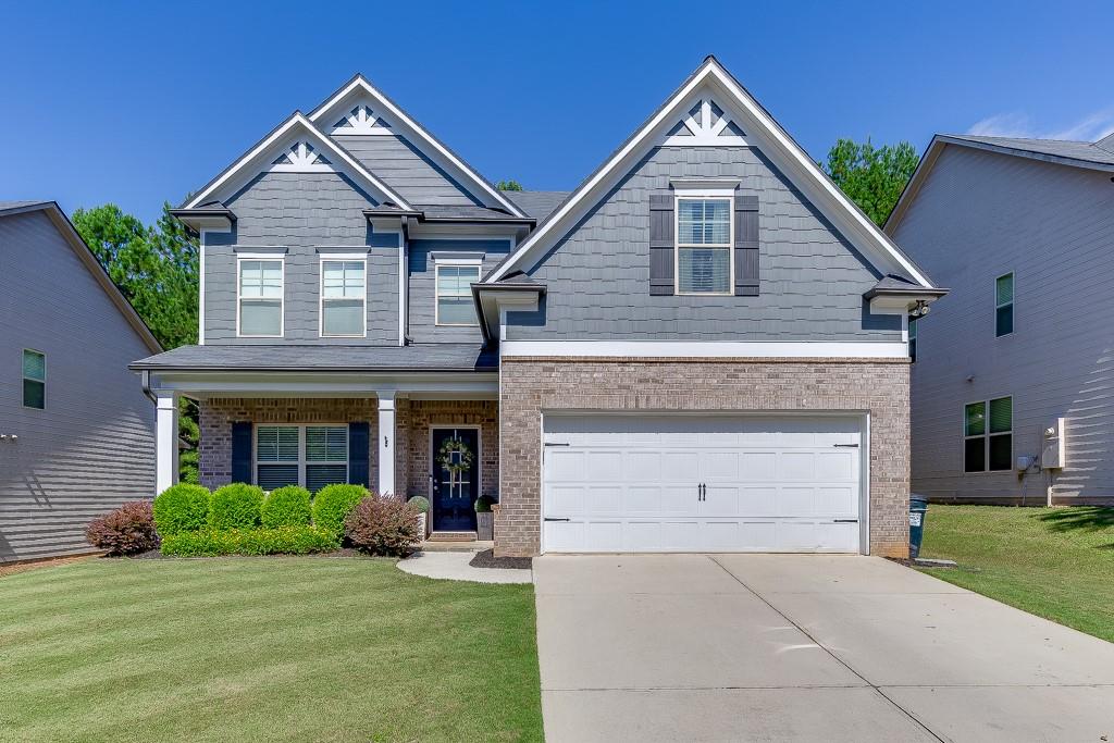 Freshly painted and impeccably maintained, this home offers a true turnkey opportunity your buyers will love. Thoughtfully designed with a guest suite and dedicated office on the main level, plus an oversized loft/media room upstairs perfect for flexible living. The gourmet kitchen impresses with granite countertops, a large center island, 42” white cabinets, and a classic subway tile backsplash—ideal for everyday living and entertaining. Wide-plank 5” hardwoods flow throughout the main level, adding warmth and style. Step outside to a custom covered patio with a built-in fireplace and a fully fenced backyard—ready for year-round enjoyment. Located in a swim/playground community with sidewalks and easy access to I-85, Chateau Elan, and NEGA Medical. 100% USDA financing eligible.