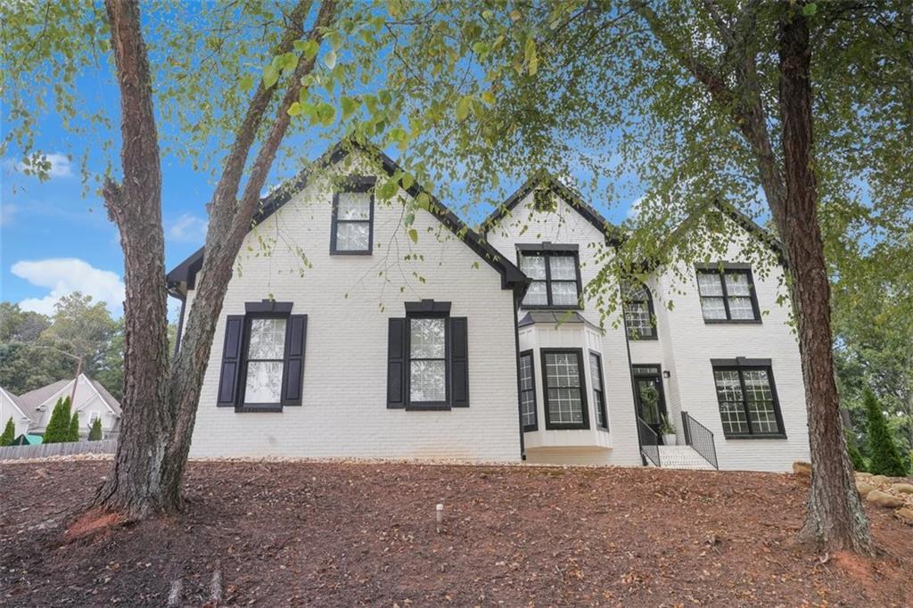 A Stunning HGTV-Worthy Home with Luxurious Southern Charm Has Come to Marietta Located in the Due West School District! This stunning Marietta residence has been thoughtfully transformed from top to bottom, completing the amazing renovations and upgrades while blending modern touches with timeless character. From the moment you step through the custom double front doors, you’re welcomed into bright, airy spaces that invite you to relax, entertain, and enjoy the seamless connection between indoors and out. The grand foyer makes a statement with a breathtaking chandelier—an architectural masterpiece that cascades light across the space like liquid gold. Its elegant design, dramatic scale, and shimmering detail create a sense of grandeur and warmth that sets the tone for the home. You can almost hear the soft hum of conversation, the clinking of glasses, and imagine every gathering feeling effortlessly stylish. Inside, sunlight pours through re-framed windows with built-in storage, illuminating soaring ceilings, gleaming refinished hardwood floors, plush new carpet, and recessed lighting. Every room tells a story: a handcrafted fireplace mantle anchors the living room, built-in shelving displays keepsakes, and a cozy storage bench invites you to linger. Board-and-batten accents, elegant fans, and carefully designed walls—opened for flow and partially closed to create a quiet office—show how seamlessly style meets function. The gourmet kitchen is a showstopper with custom cabinetry, sparkling white quartz counter tops, an over sized porcelain farmhouse sink, pot filler, and a custom wine rack. The crown jewel is the oversized Z-Line gas stove with dual ovens—perfect for hosting holiday dinners, experimenting with new recipes, or creating weeknight meals with flair. Bathrooms feel like indulgent escapes, each curated with subway-tiled showers, black fixtures, modern mirrors, and bold black inlaid sinks in the master suite. The owner’s suite is a dream, featuring white quartz counter tops and a custom walk-in closet with built-in drawers and shoe shelving—effortlessly luxurious yet functional. The finished basement offers a full secondary living space with its own kitchen, custom shelving, and plush carpeting—ideal for multi generational living, guests, or simply extra flexibility and comfort. Step outside to your private retreat! The exterior has been freshly painted, with new siding and fascia, a new gutter system, an updated deck, and a custom pergola that make outdoor entertaining effortless. Picture summer barbecues, cozy evenings by a fire pit, or quiet mornings with coffee under the pergola—surrounded by lush landscaping and plenty of room for kids to play and four-legged friends to roam on this double-corner lot. Meticulously designed with all-new interior doors and updated hardware, smart thermostats, upgraded electrical and plumbing, built-in window storage, and more. Fans in every bedroom, custom cabinetry, drawers, and shelving throughout make this home not just beautiful but fully functional. Nestled in a highly regarded school district, this home offers everything you’ve been looking for—the perfect blend of style, comfort, and southern hospitality. Blending luxurious farmhouse décor with the finest southern charm, this home is more than move-in ready—it’s the lifestyle you’ve been dreaming of.