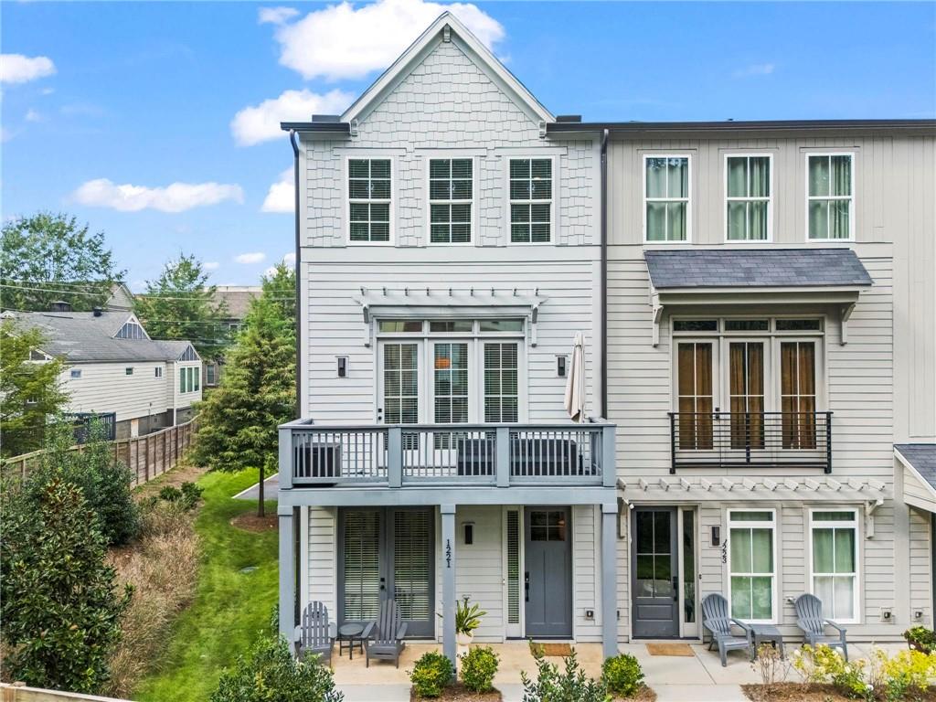 Better than new end unit townhome only minutes to the Eastside Beltline Trail! At only three years young, this absolute turn-key home will surely impress even the most discerning Buyer. Long list of upgrades including nearly every light fixture in the home, ceiling fans in every bedroom, custom closets and pantry build-outs plus hand-selected flooring and paint color selections. Ideal split bedroom floorplan is perfect for families, roommates, or even work form home scenarios. Ground floor features the welcoming foyer and drop zone, a full bedroom and bathroom suite, as well as a sizable two-car garage with generous storage. On the main level, entertaining is a dream in this open-concept floorplan connecting all social spaces. The gourmet kitchen will delight any at-home chef (or UberEats connoisseur, we won’t judge) with its massive island, designer range hood, trendy finishes, and large pantry. Don’t miss the moody powder room and two porches on this floor! Upstairs, the primary suite is a serene retreat boasting tons of natural light from the corner windows, a luxurious dual vanity bathroom, and two walk-in closets. The additional guest bedroom upstairs is supersized and with another private bathroom and large closets. Having the laundry room on the top floor makes the inevitable chore a bit more manageable. In real estate, location is everything and this home surely delivers. End-unit floorplan offers extra windows throughout the home and quieter living on Oxley Place, not fronting busy Hardee Street. This charming community is steps to the Edgewood Shopping District with countless restaurant, retail and grocery options. Less than five minutes to all the fun on the Beltline too! Fee simple ownership style allows for a lower interest rate and very low HOA fee, only $169 per month. You will be hard pressed to find a better combination of size, finishes, and location for this price point. Welcome home to 1221 Oxley Place, where life is good and living is easy!