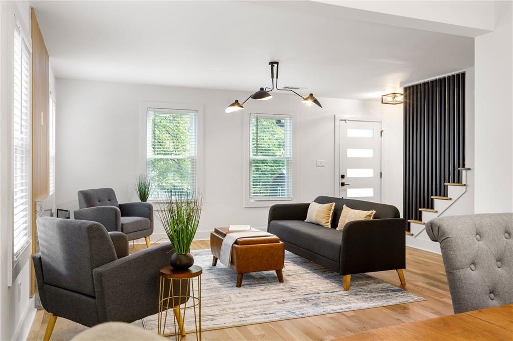 This East Atlanta showstopper has everything buyers are looking for: bold design, thoughtful upgrades, and serious flexibility. Tucked in one of the city’s most desirable neighborhoods, this fully renovated contemporary home offers four bedrooms, three and a half baths, and two primary suites—ideal for guests, roommates, or multigenerational living. Step inside to rich oak hardwoods, soaring ceilings, and an open layout that’s bathed in natural light. A dramatic wall of windows frames the living room, anchored by a sleek fireplace and flowing into a spacious dining area and fenced backyard—complete with a patio perfect for grilling or sipping coffee under the trees. The chef’s kitchen stuns with modern wood-grain cabinetry, quartz counters, designer backsplash, and a five-burner gas range—ready for your next dinner party or casual weeknight in. The main level also includes a guest bath, newly added laundry room, and the first of two luxurious primary suites with a spa-like ensuite bath. Upstairs, you'll find two bright guest rooms, a beautifully updated hall bath, and the second primary suite featuring a walk-in closet and private bath. Major upgrades include all-new siding, windows, electrical, plumbing, HVAC, and fresh paint—inside and out. Location is KEY: just minutes from East Atlanta Village, the Beltline, and Edgewood Retail, with seamless access to Midtown, Decatur, Emory, and major interstates—this home puts the best of Atlanta right at your doorstep. The seller is extremely motivated, so if you're looking for an incredible value, this is it!