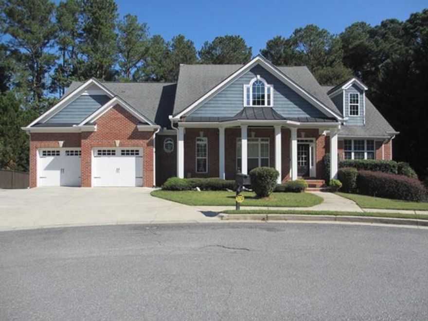 Don’t miss this rare opportunity to own a beautiful 3-sided brick traditional ranch with a full finished basement, tucked away in a highly sought-after enclave of just ten homes, perfectly positioned in the center of a cul-de-sac. Step onto the inviting front porch and enjoy serene views of lush greenery and meticulously landscaped surroundings. Inside, the main level features a formal dining room, ideal for hosting dinner parties, and a spacious great room with a cozy gas fireplace, perfect for gatherings or quiet evenings. The open kitchen offers an eat-in breakfast area, walk-in pantry, and custom cabinetry, seamlessly connecting to a light-filled sunroom overlooking the large wooded lot—ideal for enjoying your morning coffee. Gleaming hardwood floors throughout the main level add timeless charm.The main-level primary suite boasts tray ceilings and a luxurious bath with vaulted ceiling, jetted tub, double vanity, separate shower, and walk-in closet. Two additional bedrooms share a Jack-and-Jill bath, complemented by a small office and mud area. A walk-up attic provides additional storage.The finished basement is an entertainer’s dream, complete with guest bedrooms, exercise room, laundry, workshop with ample storage for tools, equipment, bikes and more. Host unforgettable gatherings in the music room enjoying some karaoke and a nice wet bar. Walk out to the private backyard retreat, backing onto green space for privacy and a natural setting. This friendly neighborhood is close to hospitals, shopping, restaurants, and Hurt Park with playgrounds, sports courts, walking paths, and covered pavilions. Enjoy easy access to Marietta Square, The Battery, Cumberland Mall, Smyrna-Vinings, and major highways into Metro Atlanta. The right updates and decorator touches will make this a showplace to enjoy for generations! Extras you’ll love: New HVAC (2023), new fence (2021), large storage shed to remain. NO HOA!