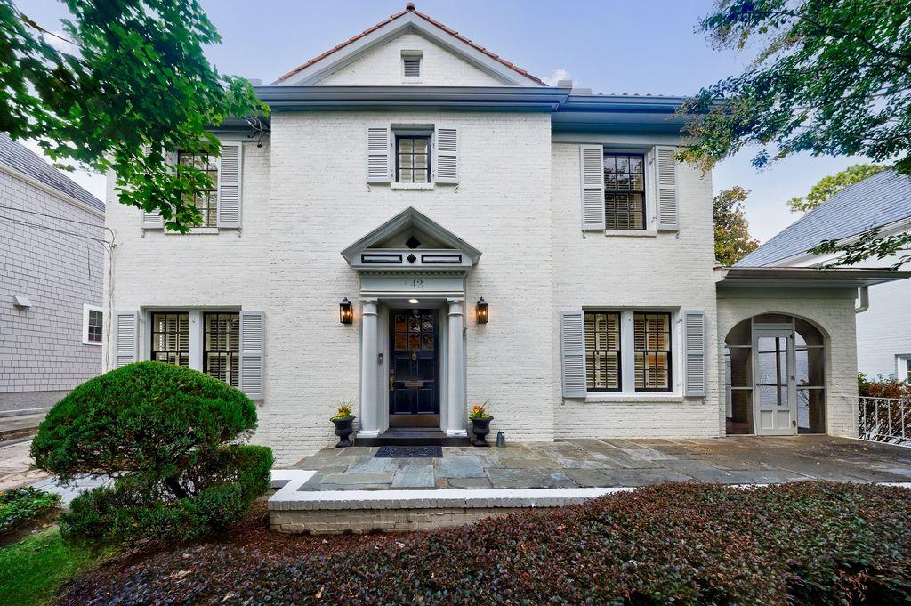 Located in coveted Brookwood Hills. This neighborhood is known for its exclusivity, tree-lined sidewalks, timeless architecture and great amenities. 42 Camden captures the most discerning buyer’s attention the moment they walk through the door. This beauty captivates the eye with its elegant tone- high ceilings, arched doorways and Nancy Myers inspired kitchen. The main level was designed for gathering-with the bright and inviting open floor plan, thoughtfully designed for both everyday living and effortless entertaining. Two fireside living areas flow seamlessly into the dining space and designer kitchen, creating a warm and connected atmosphere. Expansive windows fill the rooms with natural light, while the open design allows guests to mingle with ease. Whether hosting a gathering or enjoying a quiet evening in, the layout encourages connection and conversation, all while offering plenty of room to relax and entertain in style. Upstairs, the owner’s suite is spacious and inviting. A walk-in closet provides ample storage and organization, while the spa-like bath with vaulted ceiling features dual vanities, a soaking tub, and a separate glass-enclosed shower. There are two additional spacious bedrooms (one with an en-suite bath), gleaming hardwoods and ample storage. The driveway leads to the professionally landscaped outdoor dining and living area and detached garage offers plenty of storage. Voluntary membership in the Brookwood Hills Community Club is available immediately to neighborhood residents. Residents enjoy proximity to high-end shopping, dining, and excellent schools.