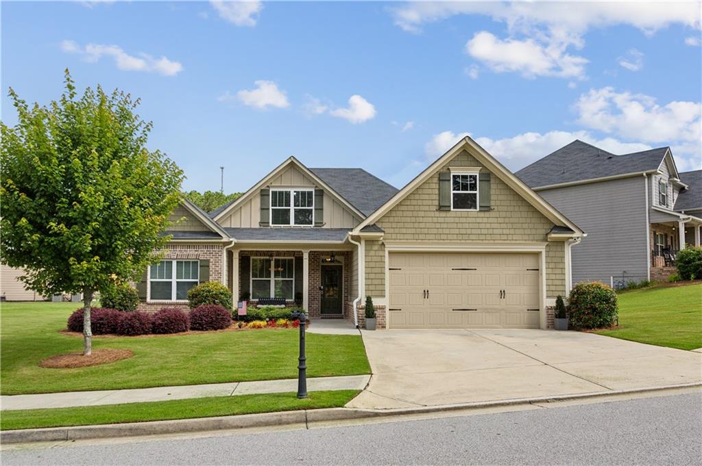 Welcome to this stunning ranch-style home featuring a versatile floor plan, perfect for modern living and entertaining. Boasting 4 spacious bedrooms thoughtfully designed with custom built-ins in all closets and 3.5 bathrooms, this home offers room for everyone. The open-concept living space includes soaring vaulted ceilings, abundant natural light, and a cozy brick fireplace. Enjoy seamless hardwood flooring throughout the entire home, including bedrooms. The kitchen is a chef’s dream with granite countertops, stainless steel appliances, white cabinetry, a pantry for optimal organization and storage and a bright dining area that overlooks the backyard.
Enjoy the convenience of a main-level primary suite and a large upstairs bonus bedroom with a private bath—perfect for guests or multi-generational living. Additional highlights include a generous attic space ideal for storage, a two-car garage, and a welcoming covered front porch. The manicured lawn and thoughtful landscaping create a warm and inviting exterior. Located in a peaceful, well-kept neighborhood just minutes from shopping, dining, and excellent schools—this home truly has it all!