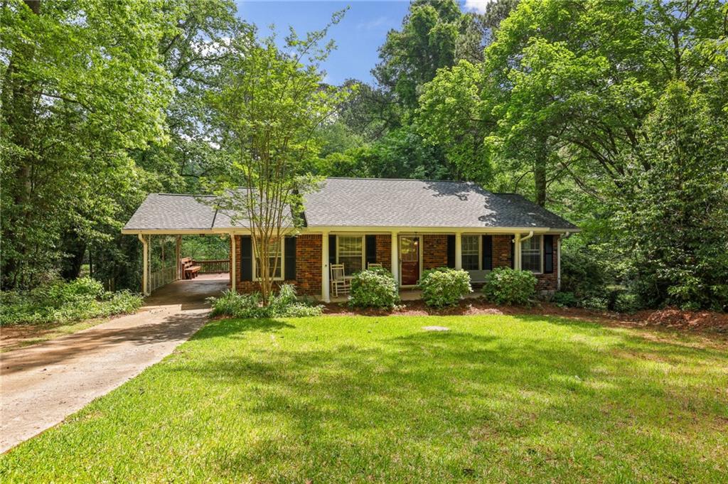 Welcome to this beautifully updated home nestled on an expansive 0.4-acre lot, offering privacy, charm, and convenience in one of Chamblee’s most sought-after neighborhoods, Wakefield Forest. Surrounded by lush, landscaping, this move-in-ready property boasts freshly painted interiors and abundant natural light throughout. Inside, you'll find beautiful hardwood floors, a spacious family room perfect for relaxing or entertaining, and a separate dining room ideal for gatherings. The recently updated kitchen features stainless steel appliances, custom cabinetry, granite countertops, and plenty of sunlight. The updated bathrooms reflect modern taste and functionality, while the generous backyard deck offers a tranquil escape—perfect for entertaining guests or enjoying peaceful summer evenings overlooking your large, private and fenced-in yard. Located just minutes from Buckhead, Brookhaven, Emory, and MARTA, with quick access to I-85 and I-285, this home offers both serenity and city convenience. Don't miss this rare gem in the Brookhaven/Chamblee area! Buyers, this beautiful property qualifies for 100% financing (no downpayment required) through Truist's CHIP Program, subject to Borrowers qualifications. For more information contact Jeff Nicholson at Truist.