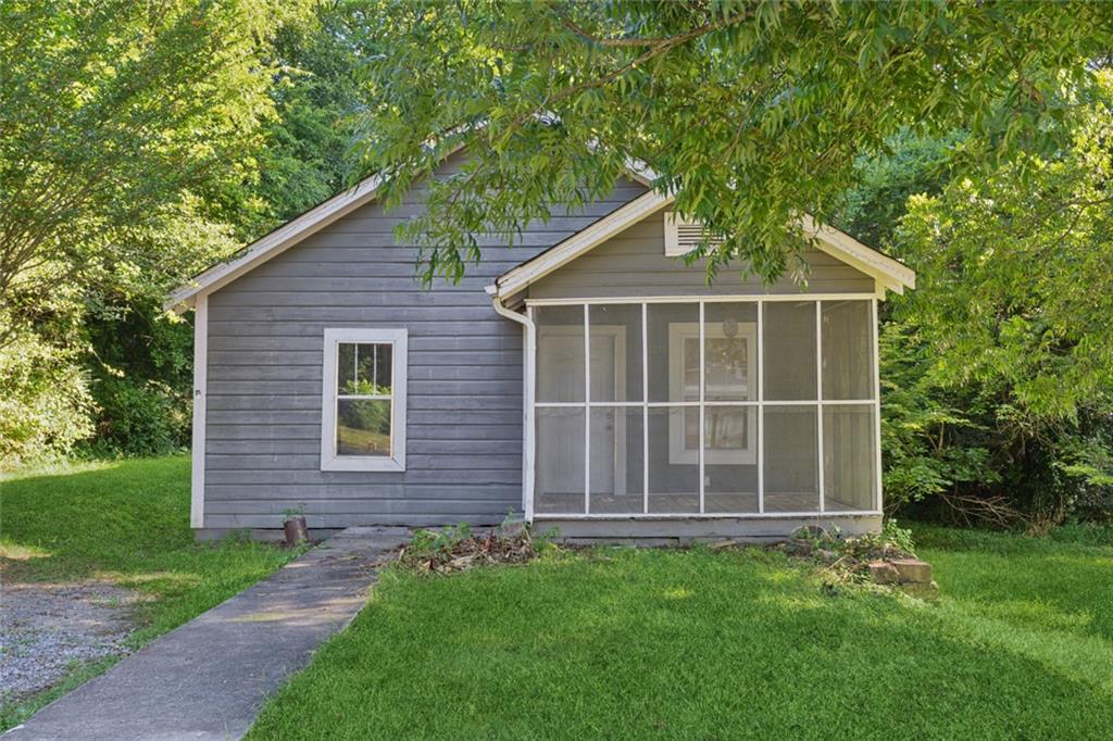 Charming bungalow just waiting for a new buyer to bring out it's potential. Lots of outdoor possibilities with a screened in porch in front and brand new deck in the back, all on over a third of an acre. The neighborhood is enjoying a resurgence with new homes being constructed and older homes being remodeled. The home is walking distance to Historic Downtown Rockmart and all it has to offer including many diverse restaurants and shops. Also, close to Nathan Dean Bypass, Highways 278, 113, and 101 and the Silver Comet Trail. Home is being sold as is due to needed work and is priced accordingly. Conventional or cash only. Will not go FHA or VA.