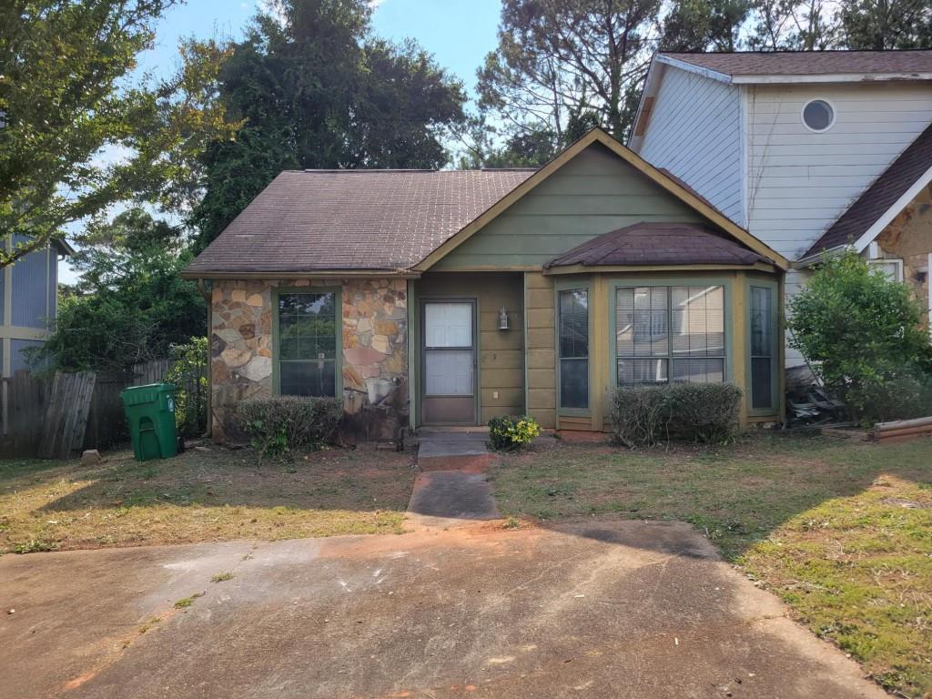 Fire damage! Good opportunity to totally renovate this end unit townhouse in Stone Mountain. Easy one-level floor plan with split bedrooms. Sun room and separate dining room. Fireplace in living room. Storage room outside. Level private fenced backyard. 2 private parking pads. No HOA dues or restrictions! AS IS. No disclosure. Utilities not available for inspections. Seller prefers 0 due diligence.