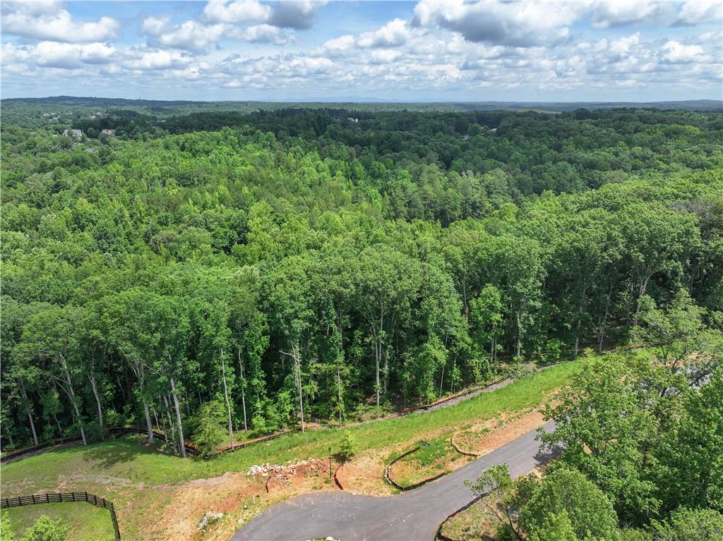 Introducing a collection of 19 extraordinary custom homes. The charm of nature’s splendor meets the sophistication of modern living at The Ridge at Sweet Apple. This is the final phase of the incredibly successful Sweet Apple neighborhoods developed by Brightwater Homes, and it features the most exclusive homesites. The community is designed to offer an unparalleled experience, combining luxury and tranquility with the conveniences of city life just a short distance away. Be the first to select one of the finest lots in the community. Lot 12 offers a level, gently sloping lot that backs to the City of Milton’s 106-acre Lakhapani Preserve offering incredible privacy. Neighborhood amenities include a private, dedicated 20-acre nature preserve with two fire pits, a fishing dock, bocce ball court, community garden, and miles of private hiking trails. Located only 2 miles from Crabapple’s City Center and a short 10-minute drive to both Downtown Alpharetta and Milton, this location provides the perfect balance of seclusion and access to local dining, shopping, and entertainment. Design and build your custom home with one of our builder guild approved exclusive builders. Finished homes will be priced from $2M+.