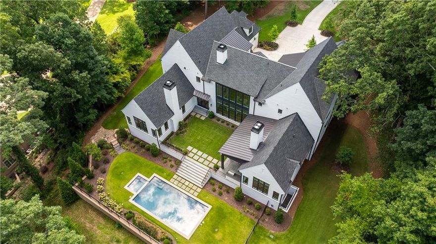 Beautifully crafted new construction home in Buckhead! Gorgeous custom home by Libi Custom Homes, design by Harrison Design and builder, Dean Johnson! This new construction home truly has it all with a sprawling main level floorpan with high ceilings, admired primary suite on main, custom wine cellar on main level and 4-car garage. Light filled entrance foyer leads to living room with an entire wall of windows looking out to the level backyard. State of the art kitchen with separate prep area opens to the keeping room with vaulted ceiling. Oversized primary suite sits in the back of the house overlooking the pool and yard. Luxurious bath with dual vanities, separate tub and shower. Outstanding walk-in closets and morning bar in the owner's suite as well. Upper level staircase leads to 4 spacious bedrooms with en-suite baths + bonus room over the garage. Finished basement with full bath has unlimited possibility. Stunning backyard with saltwater pool and covered porch with fireplace. No detail has been left untouched in this new construction home!