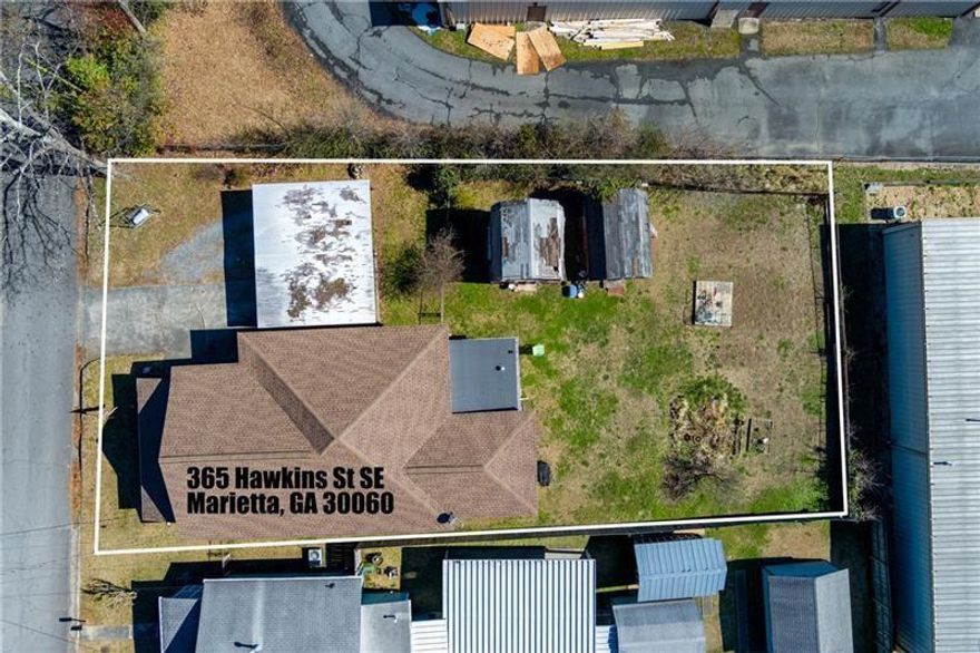 Welcome to 365 Hawkins Street in Downtown Marietta featuring a .195 acre lot with 69 feet of frontage along Hawkins Street. Surrounded by commercial industrial buildings, this property is a perfect place for your next business venture. The property is zoned LI (Light Industrial) with a single family home and outbuildings on the property from the 1950s. Utilize the land to build your business or convert the existing properties into commercial space. Less than 1 mile from Marietta Square. Please note that the neighboring property (374 Hawkins Street is also listed for sale).