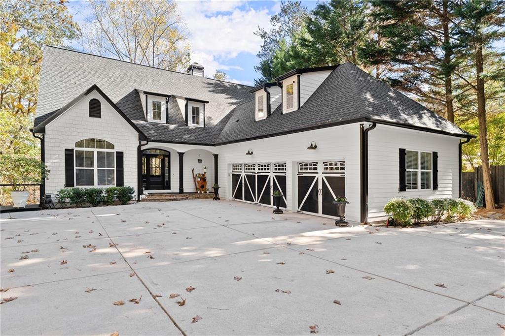 Experience lakeside luxury at its finest with this newly remodeled custom-built masterpiece nestled in a quiet, deep-water cove on beautiful Lake Lanier. With easy access to the water, year-round lake views, and a private covered dock, this is the waterfront paradise of your dreams. Step into a world of sophistication and comfort as you enter this 4-bedroom, 3.5 bath Cape Cod craftsmen gem perfectly placed on an expansive 1.37-acre lot. Home features spacious 3-car garage with newly painted flooring. New landscaping throughout entire property. At the heart of this home is an open concept living area with vaulted ceilings and large windows allowing natural light to flood the space. A floor to ceiling stacked stone fireplace provides a striking focal point to the room. The chef’s kitchen is a culinary dream boasting new appliances, large functional island with quartz countertops and custom coffee bar. All newly refinished hardwoods on main level. Retire to your primary suite with relaxing lake views and fully renovated master bath featuring all new heated porcelain
tile, beautifully well-lit vanities, and large walk-in closet. Custom shower combining functionality and aesthetic appeal with stunning tile accents. Home boasts 2-level outdoor deck with covered area perfect for entertaining guests, grilling out, or just relaxing while you soak in the natural beauty and tranquility of the lake. The terrace level/basement is perfect for additional entertainment equipped with full kitchen, bedroom with lake views, bathroom and living area. The true highlight of this level is a separate spa room with oversized swim spa surrounded by elegant teak decking. Basement could also be used for in-law suite or rental possibility with separate entry/walkway available. Your stroll down to the lake is made easier with a freshly stained walkway leading down to your recently renovated covered dock with new composite decking, generator, and boat lift. Great for fishing, parties or launching your endless boating adventures.