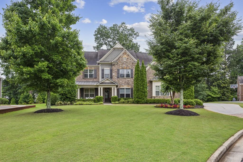 Welcome to your Dream Home in the heart of East Cobb, nestled in the highly sought-after Swim & Tennis Community of Mabry Manor. This home truly offers the best of both worlds peaceful, quiet streets in a Tight-Knit Neighborhood, while being just minutes from Top-Rated Schools, Shopping, Restaurants, and all the major highways. From the moment you pull up, the curb appeal shines with a Flat Grassy Front Yard that's perfect for play, and beautiful landscaping that frames the home just right. Located on a Circle Drive, there's very little through traffic making it extra peaceful. The Covered Front Porch with a charming porch swing is ready for your morning coffee or winding down in the evening. Step inside and you're welcomed by Dark Hardwood Floors, Crown Molding, Wainscoting, and beautiful Arched Doorways that add so much character. The Formal Dining Room flows seamlessly into the kitchen, making it perfect for entertaining. Across the hall is a stunning Home Office with Custom Dark Blue Built-Ins and a rich Walnut Desktop a stylish and quiet space to work or study. The heart of the home is the Open Concept Living Room, featuring a cozy Gas Log Fireplace, Coffered Ceilings, and Custom Wooden Shutters that let in loads of Natural Light. Just beyond that is the stunning Casual Dining Room, featuring Vaulted Ceilings, a second Fireplace, and walls of windows that create a bright, airy feel like dining outdoors all year long. The Chef's Kitchen is truly made for entertaining, with a huge Granite Island, White Cabinets, Stainless Steel Appliances, Double Ovens, and a spacious Walk-In Pantry. Right off the Garage, you'll find a practical Workshop with a built-in bench perfect for shoes, bags, and everyday drop zone organization, as well as extra storage for lawn equipment, tools, and holiday d cor. There's also a Main Level Bedroom and Gorgeous Full Bathroom with a Hexagon Tiled Shower and Wood Vanity a great setup for guests. Upstairs, the Lofted Bonus Room is an awesome, flexible space complete with Custom Sliding Wooden Doors, Built-Ins, and room for a TV. It's perfect for a Playroom, Media Room, or even a Home Gym. The Primary Suite is oversized and peaceful with Tray Ceilings, room for a sitting area or desk, and a spa-like En Suite Bathroom with a beautiful Walnut Double Vanity, Soaking Tub, and Glass Shower. The Vaulted Walk-In Closet is massive and fully built out there's room for everything. You'll also find Three additional Spacious Bedrooms upstairs Two share a Full Bath and one has its own En Suite. And yes, all the bedrooms have Walk-In Closets, which is such a rare and amazing bonus! The Laundry Room is also conveniently located upstairs with more great storage. Out back, your own private retreat awaits. The Flagstone Patio with a Wood-Burning Fireplace is absolutely perfect for hosting friends or relaxing under String Lights with a glass of wine after a long day. And the neighborhood? It's everything. Think Ladies Nights, Pizza & Pool Parties, Halloween Costume Parades (with tons of trick-or-treaters!), and even a professional-level Fireworks Show in the green space. The sense of community here is unmatched. You'll love being just minutes to Publix, gyms, Zama Mexican, Marietta Square, The Battery, Downtown Roswell, and Downtown Woodstock all your favorites are super close. With quick access to I-75 and I-285 this home offers the perfect mix of Convenience, Community, and Comfort. Don't miss your chance to call this Spectacular Home your own!
