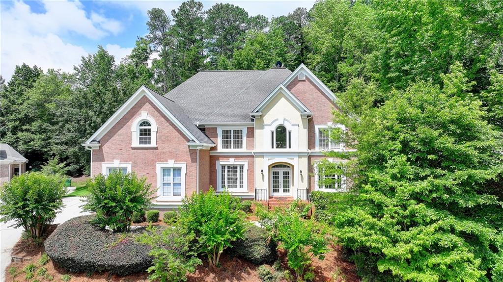 Highly Desirable Home in Seven Oaks Subdivision – Prestigious Johns Creek Location – Northview High School District!! Welcome to this stunning 6-bedroom, 5.5-bathroom home nestled in the sought-after Seven Oaks community, located in the heart of Johns Creek and zoned for the award-winning Northview High School. Situated on a beautifully landscaped, private, wooded cul-de-sac lot, this spacious, light-filled home offers exceptional curb appeal and tremendous potential. Step into the grand two-story foyer leading to the formal living and dining rooms. The bright white kitchen features a breakfast bar and flows seamlessly into the dramatic two-story family room—perfect for entertaining. A large deck overlooks the wooded backyard, offering a peaceful setting for relaxation or gatherings. The main level includes a laundry room, half bath, a guest bedroom or office, and a full bath. Upstairs, the oversized owner’s suite boasts a tray ceiling, fireplace, walk-in closets for Her and Him and a spa-inspired bath. Additional upstairs bedrooms include one with a private bath and two sharing a convenient Jack-and-Jill bathroom. Other notable features include hardwood floors, plantation shutters, front and rear staircases, and a spacious 3-car side-entry garage. The fully finished basement level offers exceptional versatility, complete with a wet bar, mini kitchenette, media room, and entertainment spaces—ideal for hosting guests or creating an in-law suite. Seven Oaks is one of North Fulton’s premier active communities, featuring resort-style amenities: an Olympic-size swimming pool, kiddie pool, 8 lighted tennis courts, pickleball courts, clubhouse, fitness center, soccer field, community lake, scenic walking trails, and a charming gazebo area used year-round for community events, graduations, wedding photos, and concerts. Enjoy the convenience of being just minutes from top-tier shopping and dining at Halcyon and Avalon, and close to Johns Creek Emory Hospital. Recent updates include freshly refinished hardwood floors on the main level, updated light and ceiling fan fixtures on two levels, and fresh paint in many areas, including the garage. Don’t miss the opportunity to own this exceptional home in one of Johns Creek’s most coveted neighborhoods!