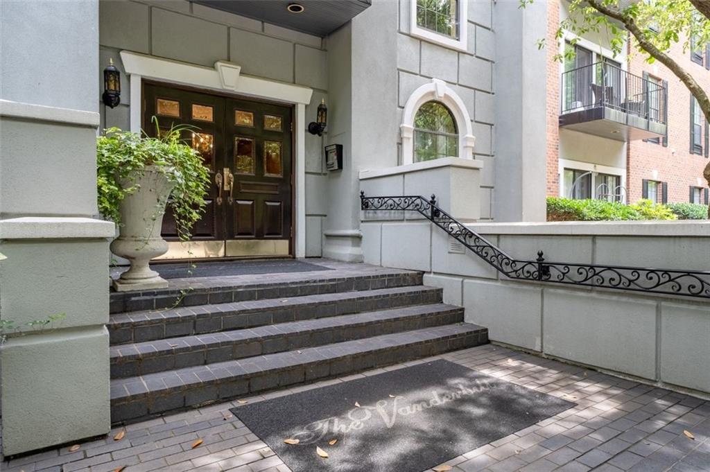 Enjoy a luxury lifestyle in this stunning 2-bedroom, 2.5-bath condominium, located in the highly sought- after gated community of The Vanderbilt. This beautifully designed end unit offers resort-style living with premium amenities, including concierge services, a saltwater pool, a fully equipped fitness center, an elegant clubhouse, and a dedicated dog walk. The bright and open living area with warm hardwood flooring is framed by three sliding glass doors that lead to a private balcony oasis with peaceful natural views. A thoughtfully designed split-bedroom floor plan provides both privacy and function, ideal for modern living. The stylish kitchen features granite countertops and KitchenAid stainless steel appliances with a cozy nook for reading, officing or dining at a bistro table. The main living space has a charming fireplace and custom built-in shelving—complete with a wine cooler—set the stage for both relaxation and entertaining. The grand primary suite offers generous space, two walk-in closets, and a beautifully finished en-suite bath. The secondary bedroom is equally versatile—perfect for guests or a home office—with a built-in Murphy bed, two closets, and a private full bath. Additional highlights include two deeded, covered parking spaces and convenient guest parking located at the front of the community. Ideally situated near I-85, GA-400, and MARTA, this residence offers unmatched access to Lenox Mall, Phipps Plaza, and many of Atlanta’s top dining, shopping, and entertainment destinations. You're also in close proximity to Executive Park, Children’s Healthcare of Atlanta (CHOA), Emory University, and the CDC. Whether you're seeking a quiet sanctuary or a vibrant city lifestyle, this exceptional condominium delivers the perfect combination of luxury, comfort, and convenience.