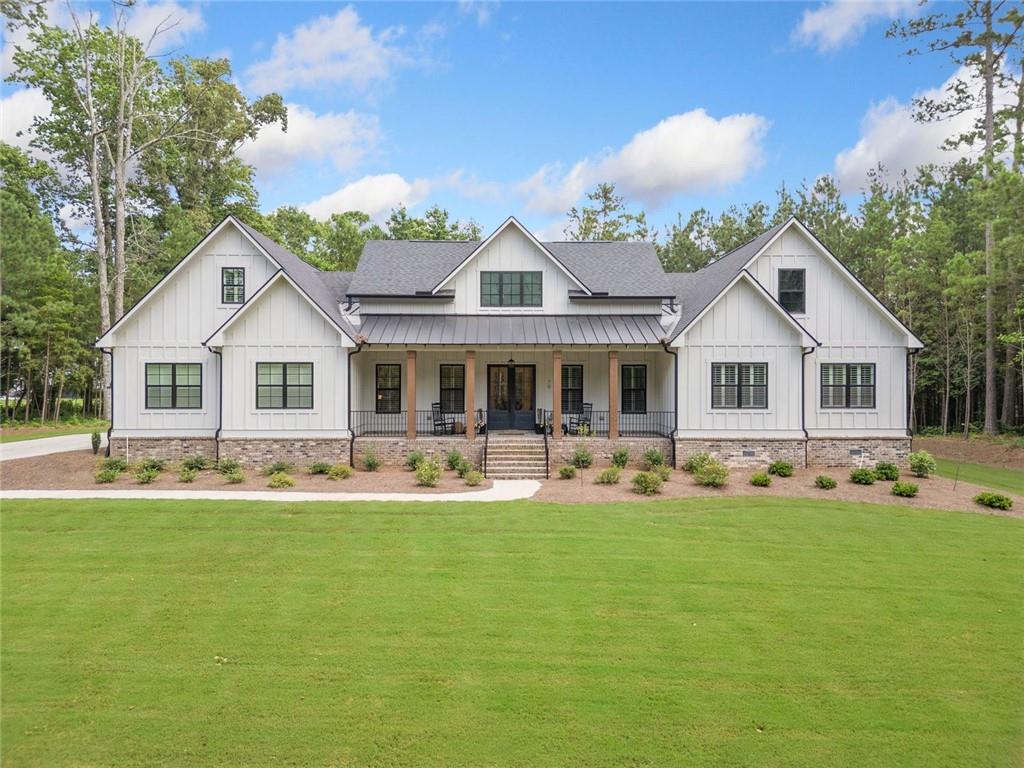 Now is your chance to own the BEST lot in Tate Reserve!!! Tucked away on nearly 2 private, wooded acres, this incredible property offers unmatched privacy—you can’t even see the home from the road, thanks to the long, scenic driveway that leads you to your own secluded haven. This stunning 5-bedroom, 4.5-bathroom home offers the ultimate blend of privacy, functionality, and luxury. This property is truly something special. Step inside to discover an open, thoughtfully designed floor plan that seamlessly connects the heart of the home. The chef’s kitchen, complete with an oversized walk-in pantry, flows effortlessly into the spacious family room—perfect for gatherings, entertaining, or cozy nights in. The primary suite is a peaceful retreat featuring a spa-like bath with a walk-in shower and soaking tub. Need to work from home? This home offers dedicated office spaces, ensuring productivity and comfort. On the opposite side of the home from the primary suite, you'll find three generously sized main-level bedrooms, perfectly positioned to offer privacy for guests, growing families, or even a potential in-law suite setup. Step out back to your expansive covered patio—ideal for relaxing or hosting guests—with custom outdoor cooking area perfect for summer nights. Surrounded by nature, the private backyard is quiet, serene, and truly one of a kind. Built in 2022, this home is truly move-in ready with every modern feature already in place—no updates needed, just unpack and enjoy. A rare find in a coveted gated community—make it yours before it's gone.