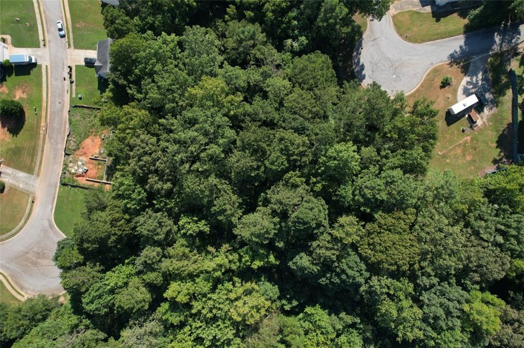 Prime Opportunity in Covington, GA! Discover two beautifully wooded lots, 9142 & 9144 to be sold together—0.72 and 0.73 acres—perfectly positioned at the mouth of a quiet cul-de-sac. With a blend of level and gently sloped terrain, these parcels offer an ideal canvas for building your dream home, plus potential for accessory dwelling units (ADUs) tucked away at the rear. Enjoy privacy, flexibility, and the freedom of no HOA restrictions, all within a peaceful, established neighborhood. Whether you're planning a primary residence, multi-generational living, or investment potential, these lots deliver space, serenity, and endless possibilities.