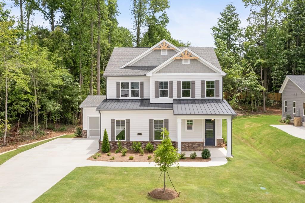 The Manor plan built by Peachtree Residential. Quick Move in! Welcome home to your lake country retreat! This beautiful 4 bedroom, master on main home will wow you inside and out. You are immediately greeted by a large 2-story foyer entry. At the rear you will find the magnificient chef's paradise kitchen outfitted with beautiful tile backsplash, hood vent, and a massive island overlooking the cozy family room with built in cabinets/bookshelves flooded by bright, natural light from the sliding patio door. The spacious master on main suite is accompanied by a spa-like bathroom with massive frameless glass shower. Upstairs you will find a sizeable loft and three secondary bedrooms that could almost serve as another primary suite. Out back is your summertime wonderland perfect for relaxation and cooking up some meals. The covered patio provides room for a nice shaded dining area and the grilling patio is ready for you to get your bbq & grill master experience on. You don't want to miss this amazing opportunity in one of Lake Lanier's most serene communities! Call today!