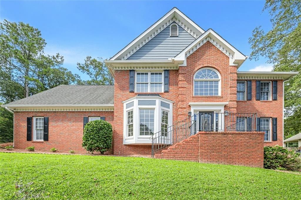 Warm, Welcoming & Multi-Generational Ready! This stately brick traditional sits on a spacious 0.65-acre lot in the highly desirable Towne Lake area—just 3 minutes to the Lake Allatoona and directly across from Hobgood Park. Featuring 5 bedrooms, 3.5 baths, plus a full in-law apartment, this home is designed for flexible living. The terrace level offers a second kitchen, breakfast area, washer/dryer hookups, and private entrance—ideal for extended family or even supplemental rental income. Recent updates include fresh interior paint, brand-new carpet and ceiling fans, dual HVAC systems (~2 years), refreshed kitchen cabinetry, and new tile in the oversized laundry/mudroom. On the main level, enjoy formal living and dining rooms alongside an open kitchen-to-family room layout with hardwood floors. Upstairs, you’ll find four generously sized bedrooms plus a huge bonus room (5th bedroom), all with walk-in closets. The extra-wide driveway provides ample parking for family and guests. Located in the sought-after Etowah High School district, this home combines space, convenience in one unbeatable package. Prime location puts you just 1.5 miles from Lake Allatoona, 2.5 miles from Eagle Watch & Towne Lake Hills Golf Clubs, 5 miles from BridgeMill Athletic Club, 6 miles from Downtown Woodstock & I-575, 7 miles to I-75, and only 15 minutes from Kennesaw State University. Shopping, dining, and all the best of Towne Lake are right at your fingertips! Don’t miss this rare Towne Lake gem—offering the perfect blend of lifestyle, location, and livability!