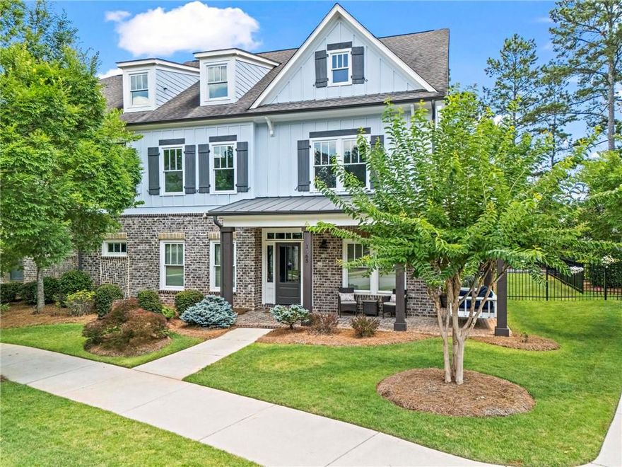 Rare opportunity for an end-unit, primary suite on main townhome WITH FENCED BACKYARD in desirable Crabapple locale! This home offers the best of both worlds; it lives like single-family but without the hassle of extensive upkeep! Friends and family alike are greeted by the southern wrap-around front porch and immediately taken back to a slower pace of life. Inside, this home boasts countless upgrades around every corner like an impressive trim package, upgraded flooring, brick accent walls, designer wallpaper and upgraded fixtures. Gourmet kitchen is the hub of the home with high-grade cabinetry, walk-in pantry, Thermador gas cooktop, double ovens, massive island, and separate beverage center in the breakfast nook. The copper pot filler impresses any at-home chef and doubles as a piece of art! Drenched in natural light, the fireside family room beckons for entertaining a crowd. The primary suite on the main level is a serene oasis fit for royalty! Luxurious en-suite washroom featuring dual vanities, free-standing tub and large tile shower plus direct access to the private first floor laundry room and two walk-in closets, both with custom cabinetry. Head upstairs to find a second living room and a second  laundry room - no toting hampers up and down the stairs here! Four additional guest bedrooms all showcase ample natural light, large closets, and direct connectivity to the three full bathrooms upstairs. An additional bonus room, currently used as the kids’ playroom, offers endless options for an office space, media room, or home gym. Outside, the covered back porch is a perfect spot to unwind after a long day and the (two) porch swings are staying with the house! Flat and landscaped, the backyard and side yard boast a newly installed fence! Meticulous Sellers have also recently replaced both HVAC units (2021 and 2024) and cared for this home with extreme attention to detail. You will be hard pressed to find a better location; between the close proximity of all of the fun shopping and restaurants in Crabapple Market to the highly-rated schools of Crabapple Crossing Elementary, Northwestern Middle and Milton High, this one checks all the boxes. Welcome home to 1565 Parkside Drive, where life is good and living is easy!