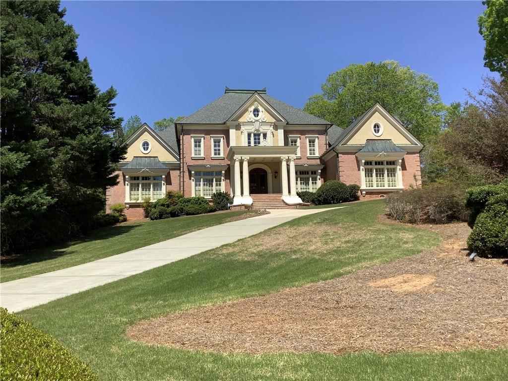 This European style all-sided brick house is located in one of Atlanta's most premier communities, Country Club of the South, on a beautiful gold course lot. A stately front portico with coffered ceiling welcomes you into the 20ft+ spacious front foyer. The floor plan is open and airy, flowing from the curved floating stairway to two-story great room, with formal dining room on the right side and study on the left. The well-appointed study has built-in book cases, a fireplace, coffered ceilings, and another door leading into master suite. Hardwood floors throughout main level, except for the marble floors in the master bathroom. Plantation shutters throughout the whole house. All five fireplaces in this house have elegant stone European mantlepieces. Main stairways have beautiful ornate wrought iron railings, while sophisticated crown moldings throughout presents the superior quality of this stately home.
* The chef's kitchen is equipped with all high-end appliances, including cook-top, convection oven, built-in refrigerator, large island with bar-height stools for casual meal, a water faucet over the cooktop to makes it easy for any cooking, a walk-in pantry with a built-in ladder, flanked by butler's pantry on both sides. Breakfast area and keeping room in open to kitchen and has a fireplace and a door going out to the upper-level patio. The combination of these areas is perfect to relax and unwind, enjoy your meals in the breakfast room or by the kitchen counter or outside on the patio looking out at the beautiful golf course…all as you like.
* The extra-large master suite on main has a spacious sitting area with yet another fireplace. Master bath has marble floors, large jacuzzi tub, shower room with multiple shower heads, separate vanities have plenty of cabinets, and a separate make-up desk, and two large walk-in custom closets. Upstairs has four bedrooms, three bathrooms. The guest suite quietly sits at one end upstairs. An large finished attic is on the third level with permanent stairs leading to it. This OVER 1000 SF SPACE IS NOT CALCULATED INTO THE TOTAL SF IN THE LISTING.
* The amazing terrace level has a newly-built fully loaded secondary kitchen, with Tiffany style lightings and recessed lights. This secondary kitchen opens to the terrace family room that also has a fireplace. A double door leads to game room, workout area, and an amazing English pub bar. Wine cellar is at the end of a hallway, with stone walls, antique wooden doors, and a tasting room. Terrace level also has a home theater, a full guest suite with full bath, an office, a hobby room, a tool room and a second full bath located between the wine cellar and theater.
* Laundry room on main adjacent to kitchen has a sink with stone countertops and cabinets/storage, and door to side parking pad by the three-car garage. Roof is about 8 years old and HAVC systems are mostly replaced over past several years. Backyard ls fenced, level and has a patio with circular brick stairs going up to the main level patio. The backyard still has ample space for your own pool to be built… otherwise, this home is only a few minutes’ walk to the community club, pools and tennis courts.
* CCOS is home to Jack Nicklaus 18 hole course, 24-7 gated & patrolled security, parks, tennis & pickle ball courts, pool, social events, private streets with golf cart access. Community Rec Center features an Olympic size pool, kids pool, slides & waterpark, basketball courts, and fields for community outdoor concerts etc.. Community Rec Center is available for personal use as well. Social and golf club are all available to join at CCOS Golf Club.
