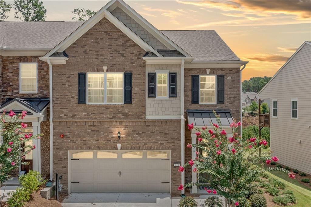 Modern design, natural light, and all the right upgrades, this 2023 build delivers the feel of new construction without the wait.
From the moment you walk in, the open layout feels effortless. The kitchen features quartz counters, herringbone tile backsplash, stainless steel appliances, and a four-seat island that’s made for everything from casual breakfasts to evening wine with friends. Wide-plank floors run throughout the main level, connecting the living and dining spaces with clean lines and warm tones.
The living area is styled with oversized windows and a painted brick fireplace flanked by custom shiplap accents, bringing both character and comfort. French doors lead out to a fenced backyard with wooded views and no direct neighbors behind you.
Upstairs, the primary suite goes beyond the basics with a private sitting area or office nook, a walk-in closet, and a bathroom that feels like a retreat. Think dual vanities, marble-look tile, a soaking tub, and a glass-enclosed shower.
Tucked in a well-maintained community just minutes from Highway 92 and I-575, this home has a smart design with everyday functionality. Stylish, practical, and truly move-in ready.