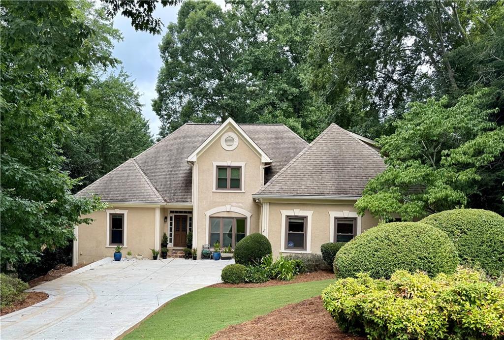 Elegant 6-Bedroom European-Style Home in Sought-After Johns Creek / Northview HS District Welcome to The Hideaway at Stonehaven-a beautifully crafted 4,930 sq ft European-style residence that seamlessly blends timeless elegance with modern comfort. Nestled in one of Johns Creek's most desirable swim and tennis communities and zoned for the top-ranked Northview High School, this exceptional home offers refined living in an unbeatable location. The home is minutes away from the Johns Creek Town Center/Medley development, set to open in 2026. With 6 spacious bedrooms and 4.5 luxurious bathrooms, the open-concept design is ideal for both everyday life and stylish entertaining. The chef's kitchen flows effortlessly into the inviting family room, while the dramatic great room showcases vaulted beamed ceilings and a striking see-through stone fireplace. The expansive main-level primary suite features elegant tilework and a generous walk-in closet. Step directly from your bedroom or family room onto a newly renovated full-sized deck-perfect for sipping morning coffee or evening wine while enjoying serene views of the pristine backyard and the gentle sounds of Johns Creek flowing just beyond the trees. Upstairs, you'll find three additional bedrooms, while the fully finished terrace level includes a large recreation room, private office, exercise room, workshop, and abundant unfinished storage space. Outdoors, your private retreat awaits: a full-length screened porch with separate lounging, dining, and bar areas overlooking a lush, landscaped backyard oasis, complete with a stone patio and cozy firepit-ideal for year-round relaxation and gatherings. This remarkable home offers the perfect blend of luxury, privacy, and location-an exceptional opportunity in one of Metro Atlanta's most prestigious communities.