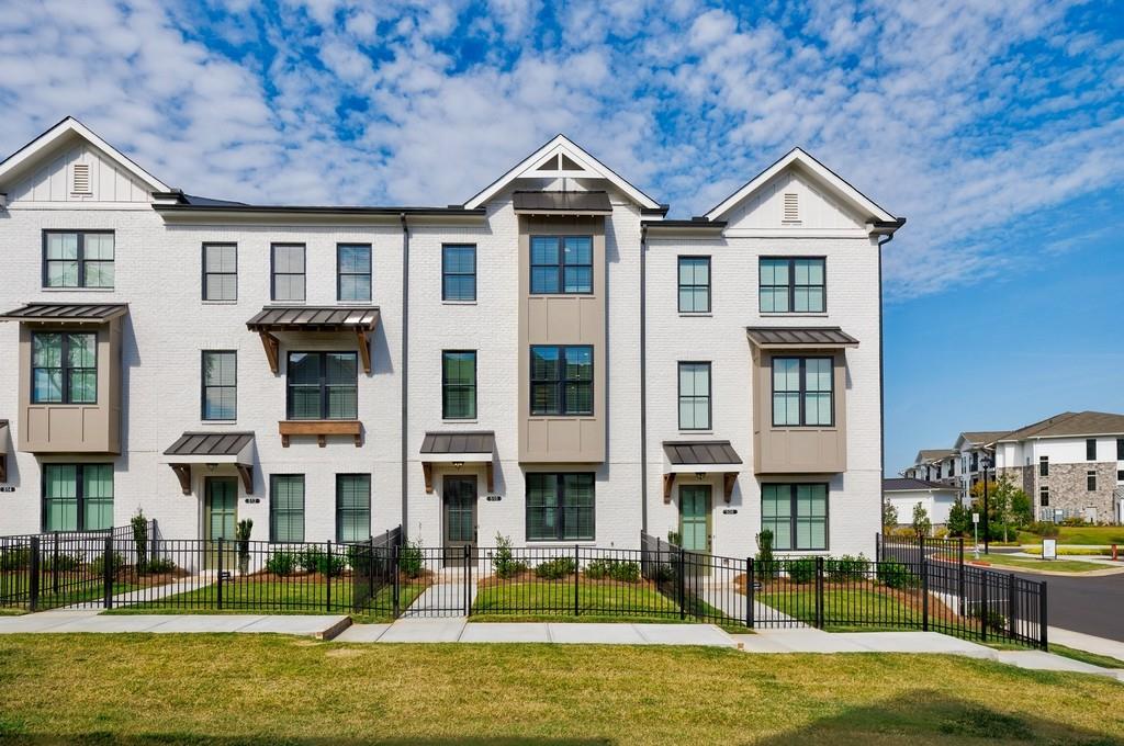Welcome home to this stunning brand-new three-story townhome designed for both style and convenience! From the moment you step inside, you'll be impressed by the modern finishes, thoughtful layout, and natural light throughout. The terrace level offers a private bedroom with French doors, a full bath, and easy access to the two-car garage equipped with an EV charging outlet perfect for today's lifestyle. The main level is an entertainer's dream, showcasing an open-concept design with a gourmet kitchen featuring quartz countertops, soft-close cabinetry, and premium GE Profile appliances. Gather around the cozy gas fireplace in the spacious living room, enjoy meals in the dining area, or sip your morning coffee in the bright sunroom that opens to a private deck your ideal spot for relaxation. Upstairs, the owner's suite is a luxurious retreat with a walk-in closet, dual vanities, and a sleek walk-in shower. A third bedroom with its own bath provides flexibility for guests, a home office, or creative space. Laundry is conveniently located on this level as well. Complete with energy-efficient features, a fenced yard, and upscale details throughout, this home offers the perfect blend of comfort, convenience, and modern living. Don't miss the chance to be the very first to enjoy this beautiful new construction townhome schedule your tour today!