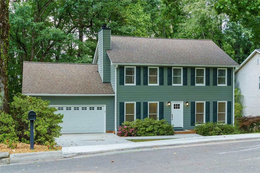 Charming upgraded colonial with NO HOA in prime Roswell location! Welcome to this beautifully well maintained Three Bed, Two and a Half Bath ~ Two Story home with partially finished basement in a peaceful tree lined setting, just minutes from everything Roswell has to offer. Perfectly combining classic charm with modern upgrades, this home offers comfortable living both indoors and out. Step inside to find a spacious living room featuring a cozy fireplace and a built in wet bar, ideal for entertaining guests or just relaxing, along with a convenient half bath and a beautifully upgraded kitchen and laundry/mud room that extends into a separate dining room with a big picture window and spacious family room. Upstairs, you'll find three generously sized bedrooms, including a primary suite with master bath, double vanities and his and hers closets, along with a second full bath that serves the other two bedrooms. The partially finished basement includes an oversized versatile bonus room that can be transformed into a home gym, craft studio, teen retreat or playroom. The heart of the home extends outdoors with a newly built, double deck, perfect for outdoor entertaining or quiet mornings with a cup of coffee. Located in a tranquil neighborhood but close to top rated schools, shopping, dining and beautiful parks, this home offers the best of both worlds- peace and privacy, without sacrificing convenience. Don't miss your opportunity to own this move in ready gem in sought after Roswell!