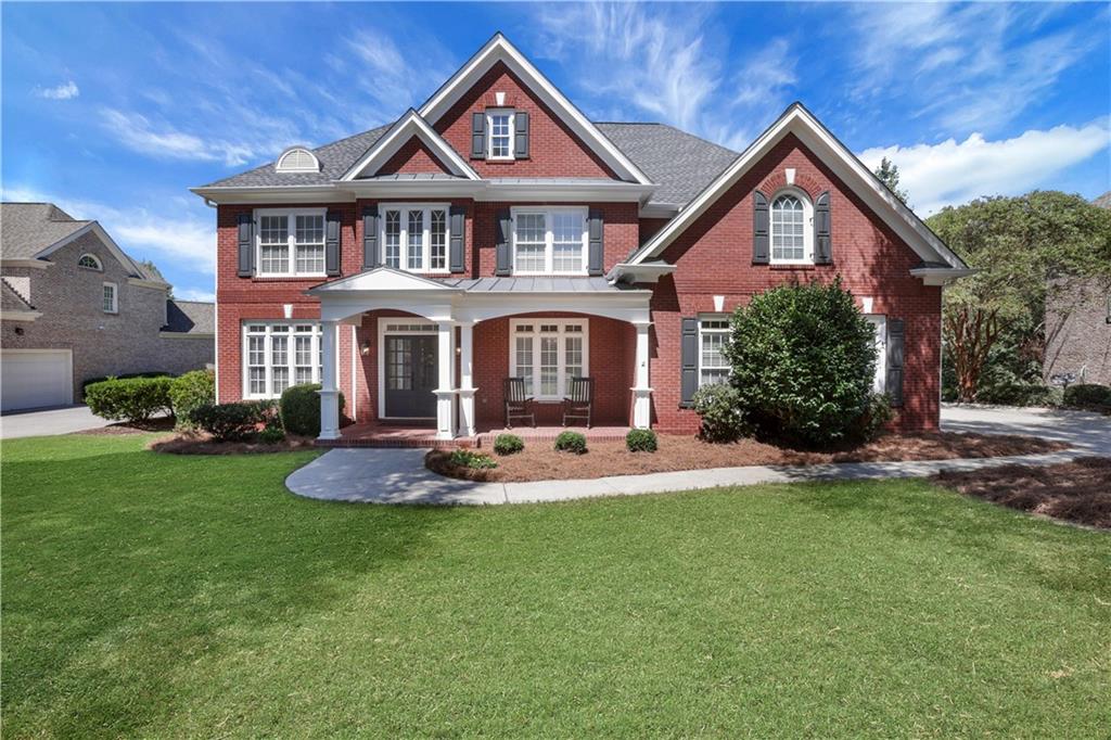 Stunning cul-de-sac home in the prestigious Grandview section of Windermere Golf & Country Club. This beautifully updated 3-sides brick home offers the perfect blend of elegance, comfort, and functionality across all three finished levels — a GREAT opportunity to be in one of Windermere’s most sought-after neighborhoods. Step inside to a bright, freshly painted interior featuring a welcoming two-story family room with a wall of windows, fireplace, and custom built-ins overlooking private wooded views. The spacious main level also includes a guest bedroom with full bath, an elegant dining room, a versatile office or living room, and a gourmet kitchen with granite island open to a cozy keeping room with its own fireplace and built-ins. Upstairs, retreat to the expansive owner’s suite with sitting room, spa-like bath, and an oversized custom closet. Three additional bedrooms, two full baths, and an upstairs laundry room complete the upper level. The fully finished terrace level is ideal for multi-generational living or a private apartment, offering a bedroom and full bath, kitchen, family room, game room, media room, and ample storage. Additional highlights include a 3-car garage, new carpet, and fresh interior paint. Enjoy resort-style amenities including championship golf, tennis, pickleball, swimming pools, fitness center, playgrounds, and miles of walking trails—all in one of South Forsyth’s most desirable communities. This one truly has it all: a flowing layout, updated finishes, flexible spaces, and sunrise views you’ll never tire of.