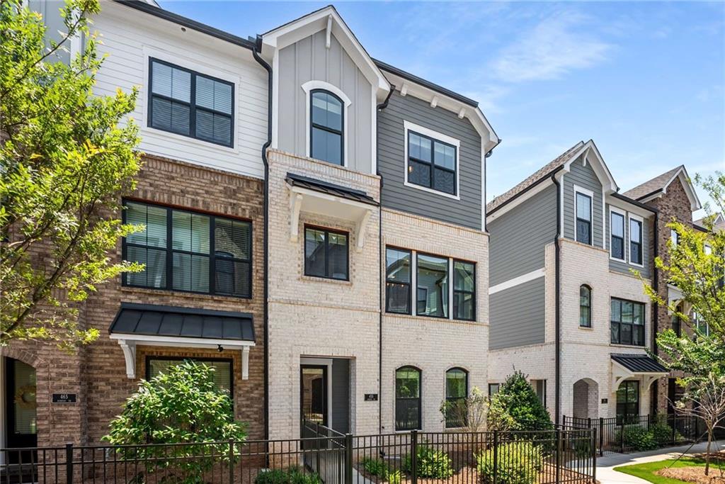 Wow!! Gorgeous end unit townhouse, 1 year new located in the perfect gated community in Roswell. This unit is quite the showstopper for sure. Completely open floor plan on main level. Gorgeous kitchen with quartz counter tops, stainless built in appliances, tiled backsplash, 5 burner gas cook top and white cabinets. Open family room with decorative accent wall molding. Lower level bedroom with full bathroom, great for guests. Nicely sized owners suite with decorative accent wall molding and awesome owners suite bathroom. 2 additional nicely sized secondary bedrooms. Laundry room up with brand new washer and dryer included as well as a stainless refrigerator. 2 car rear facing large garage. The complex is completely gated and offers a pool with cabana and dog park. It's situated minutes from downtown Roswell, Alpharetta and Avalon. GA400 is literally 5 minutes away.