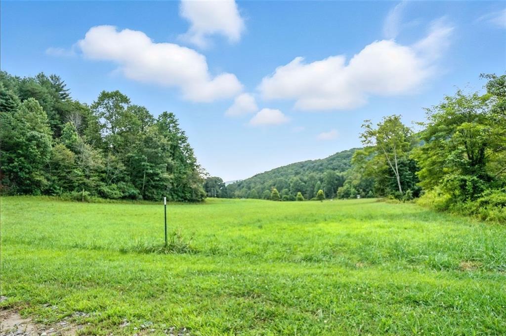 Nestled within the pristine beauty of the Chattahoochee-Oconee National Forest, and just a short drive from charming Downtown Ellijay and the majestic Amicalola Falls, lies this serene slice of North Georgia paradise. This unique offering includes two parcels totaling over 5.25 acres, providing ample space and endless possibilities for building your dream home, mountain retreat, or vacation getaway.
Breathtaking, year-round mountain views stretch across the horizon, creating a stunning backdrop for every season. A picturesque creek meanders along the edge of the property, adding the soothing sound of flowing water to the already tranquil atmosphere. Whether you envision sipping your morning coffee while watching the sunrise or simply soaking in the soothing sounds of the creek, this property delivers it all.
With fresh mountain air, and convenient access to outdoor adventures, wineries, local shops, and dining, this is truly an outdoor enthusiast’s dream location. Don’t miss the opportunity to own your own private retreat in one of North Georgia’s most scenic areas.